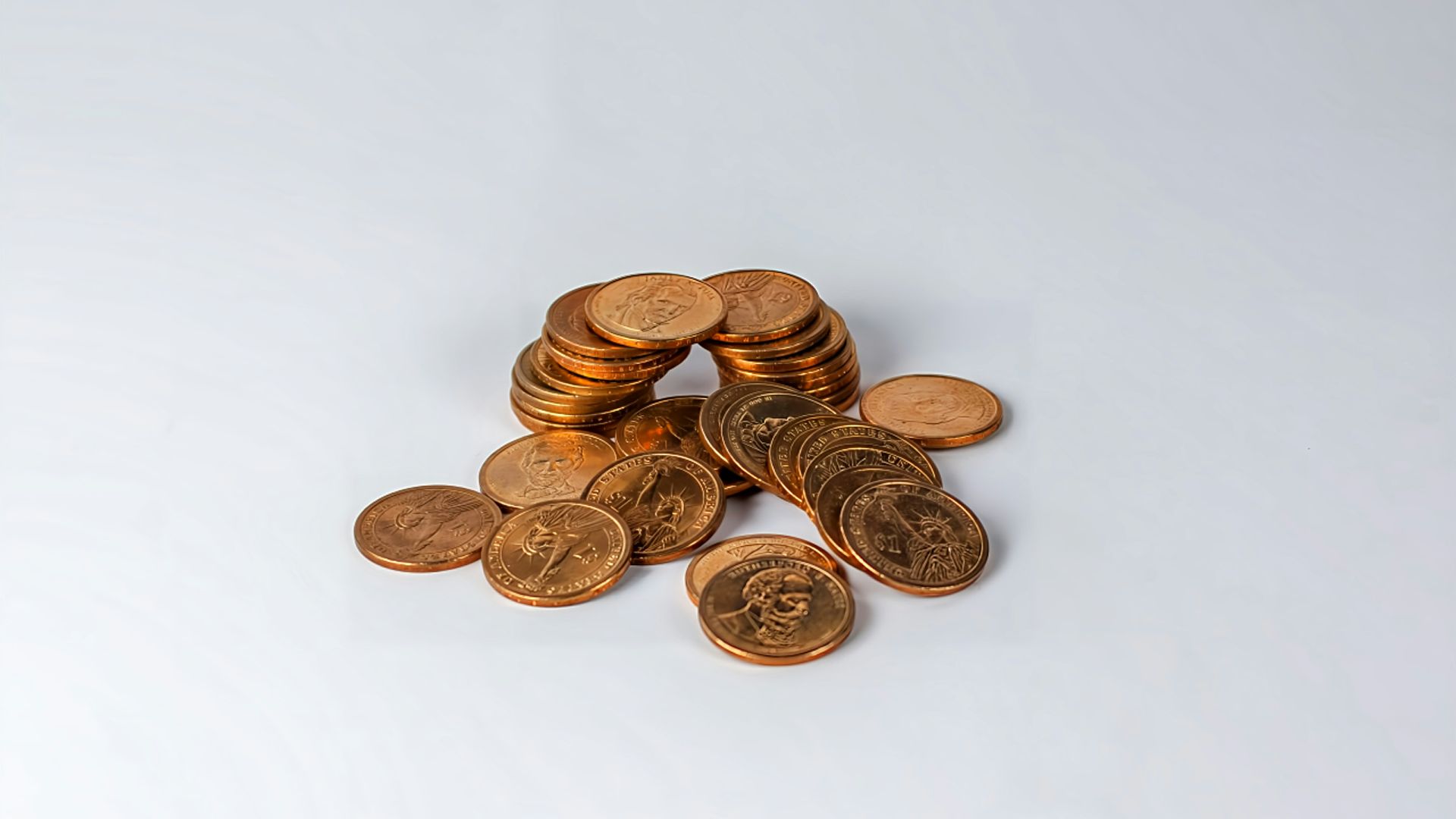 a pile of coins sitting on top of a white table