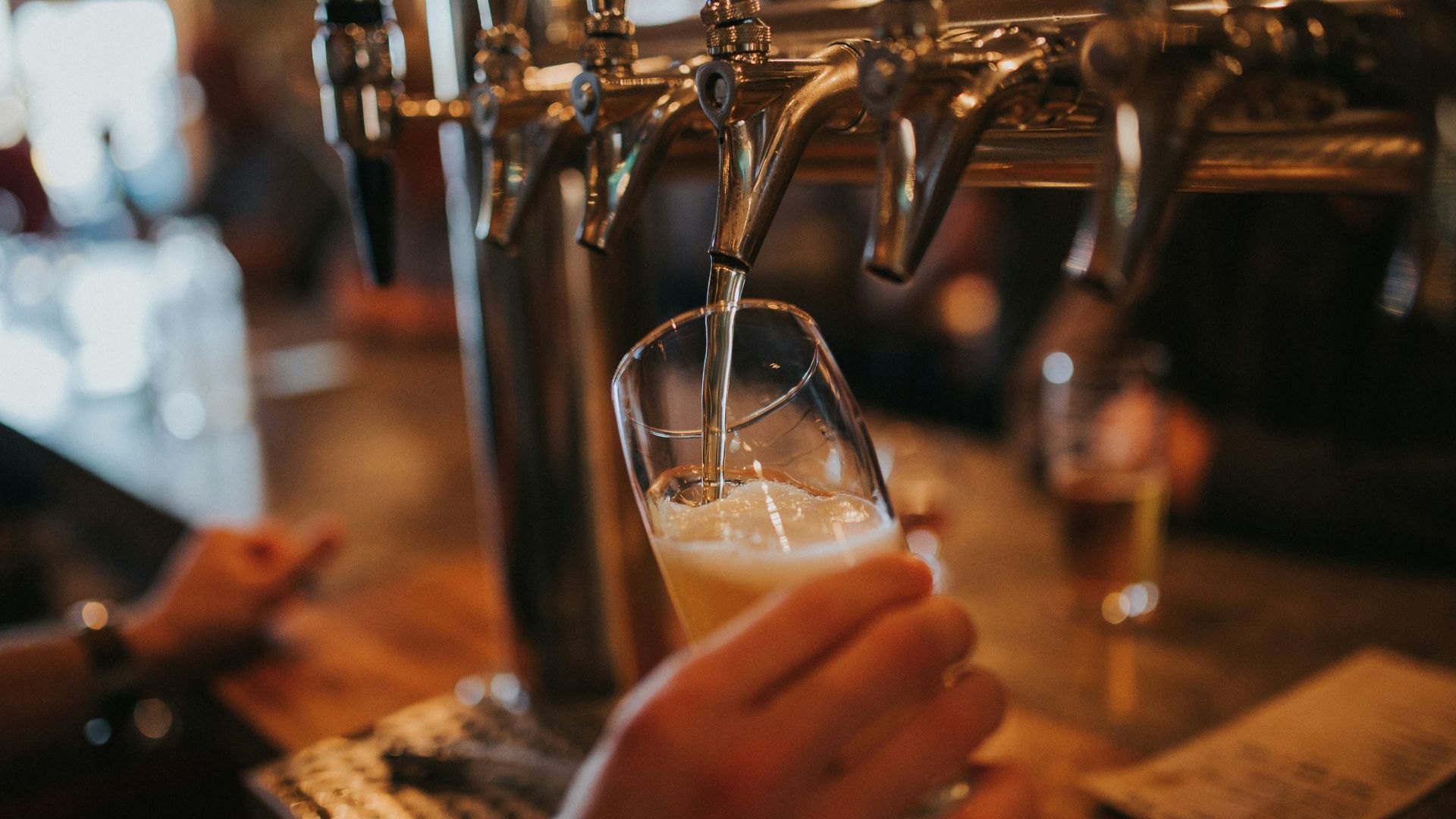 person filling beer on glass