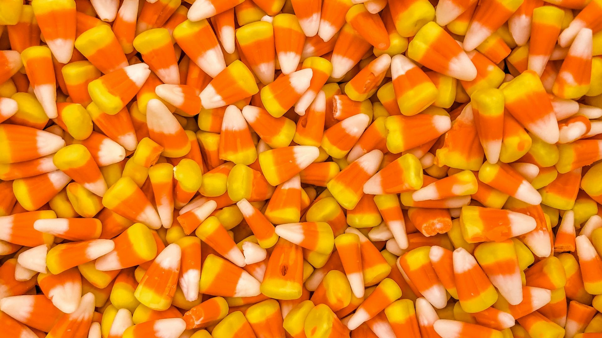 a pile of orange and white candy corn