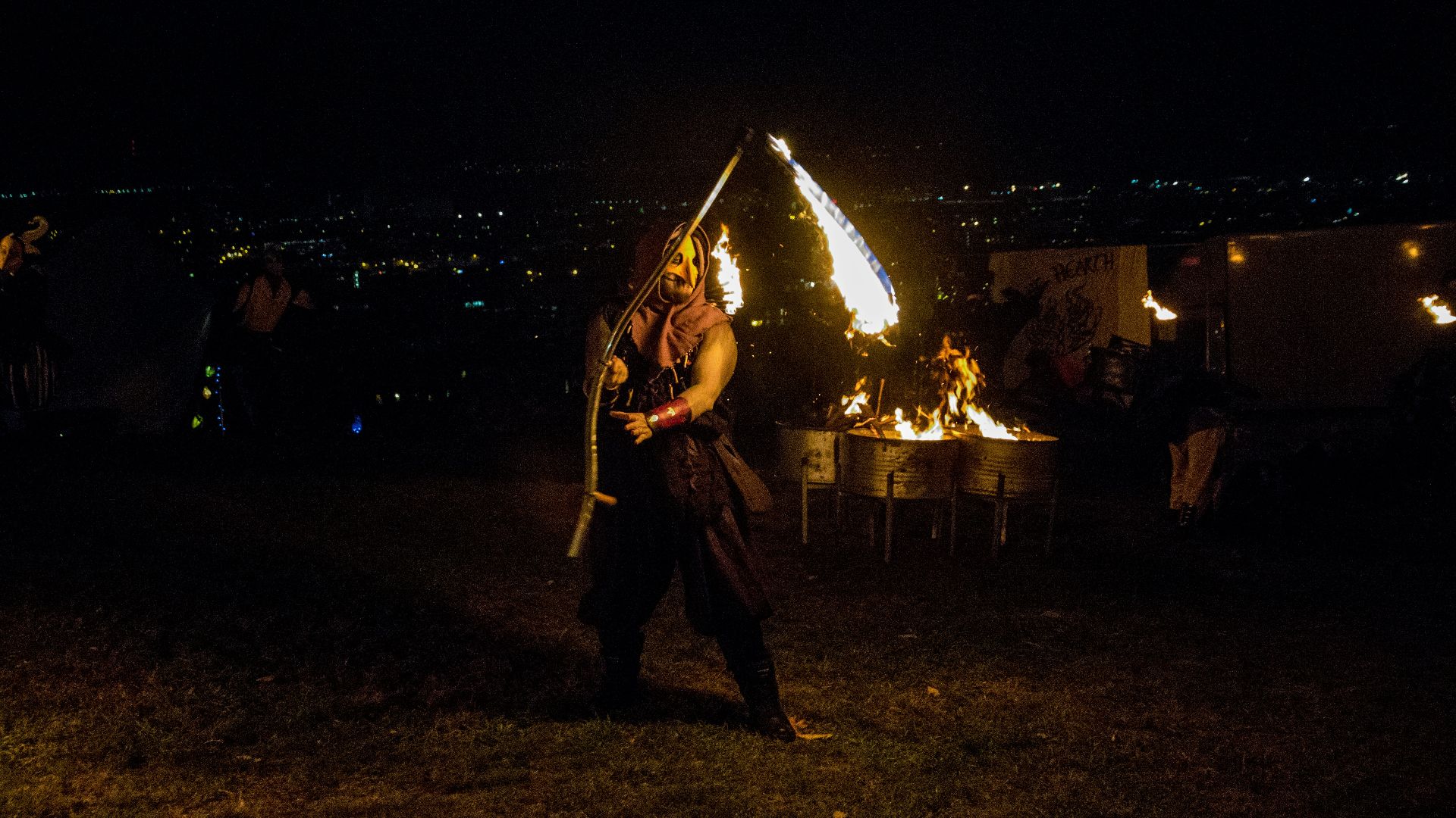 man playing guitar on the street during night time