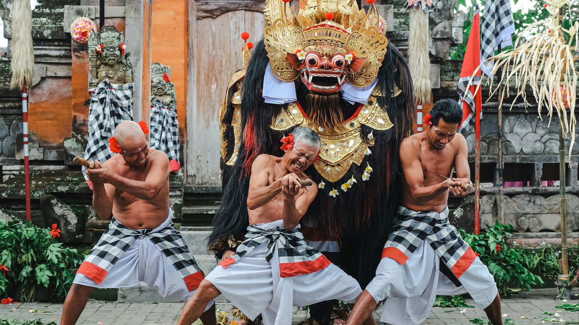 A group of men performing a dance in front of a building