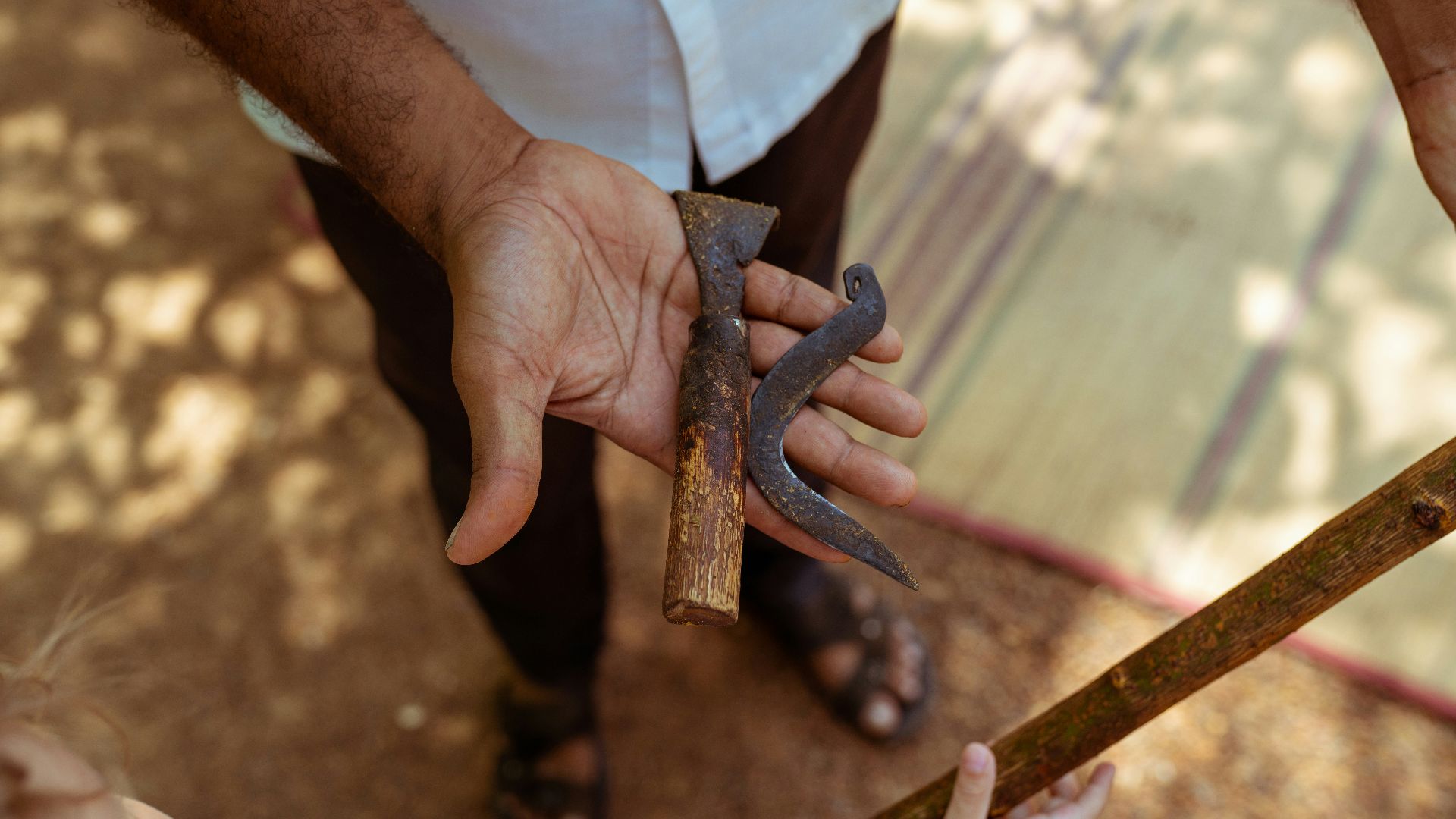 person holding brown metal tool