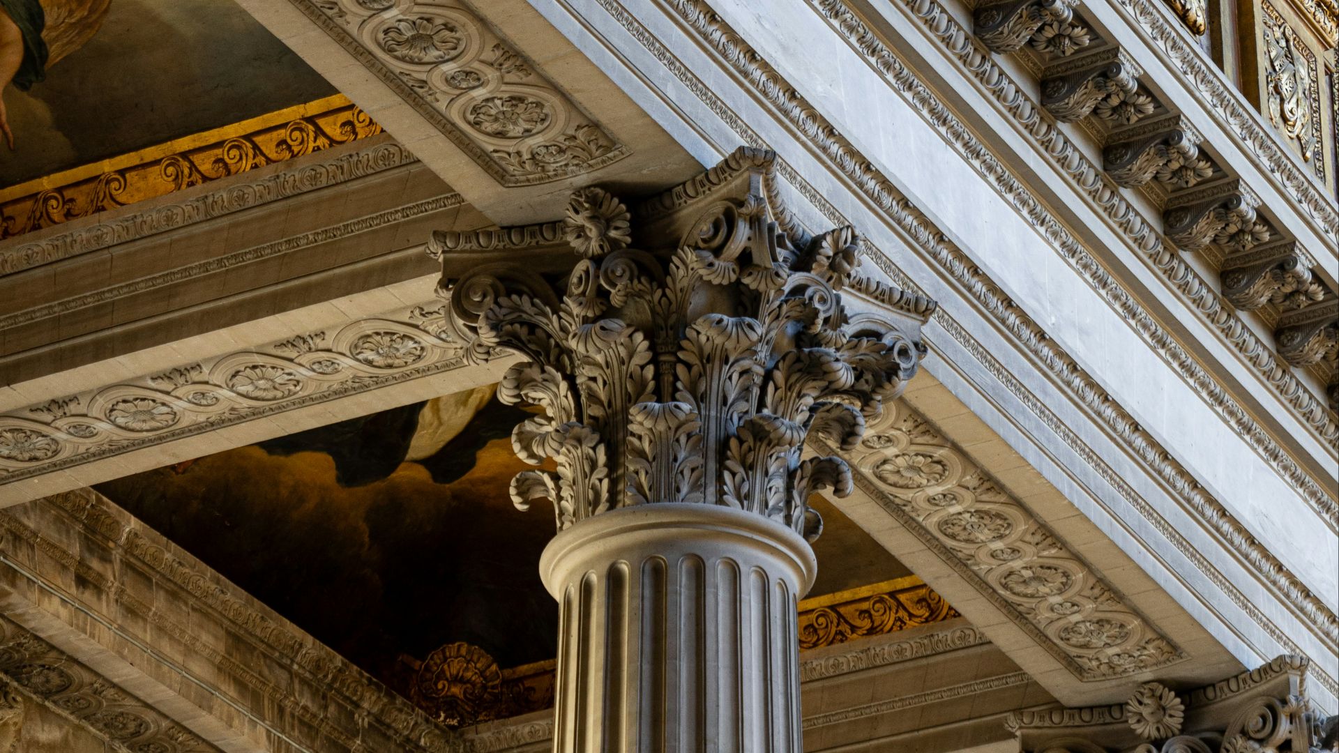 A large building with columns and paintings on the walls