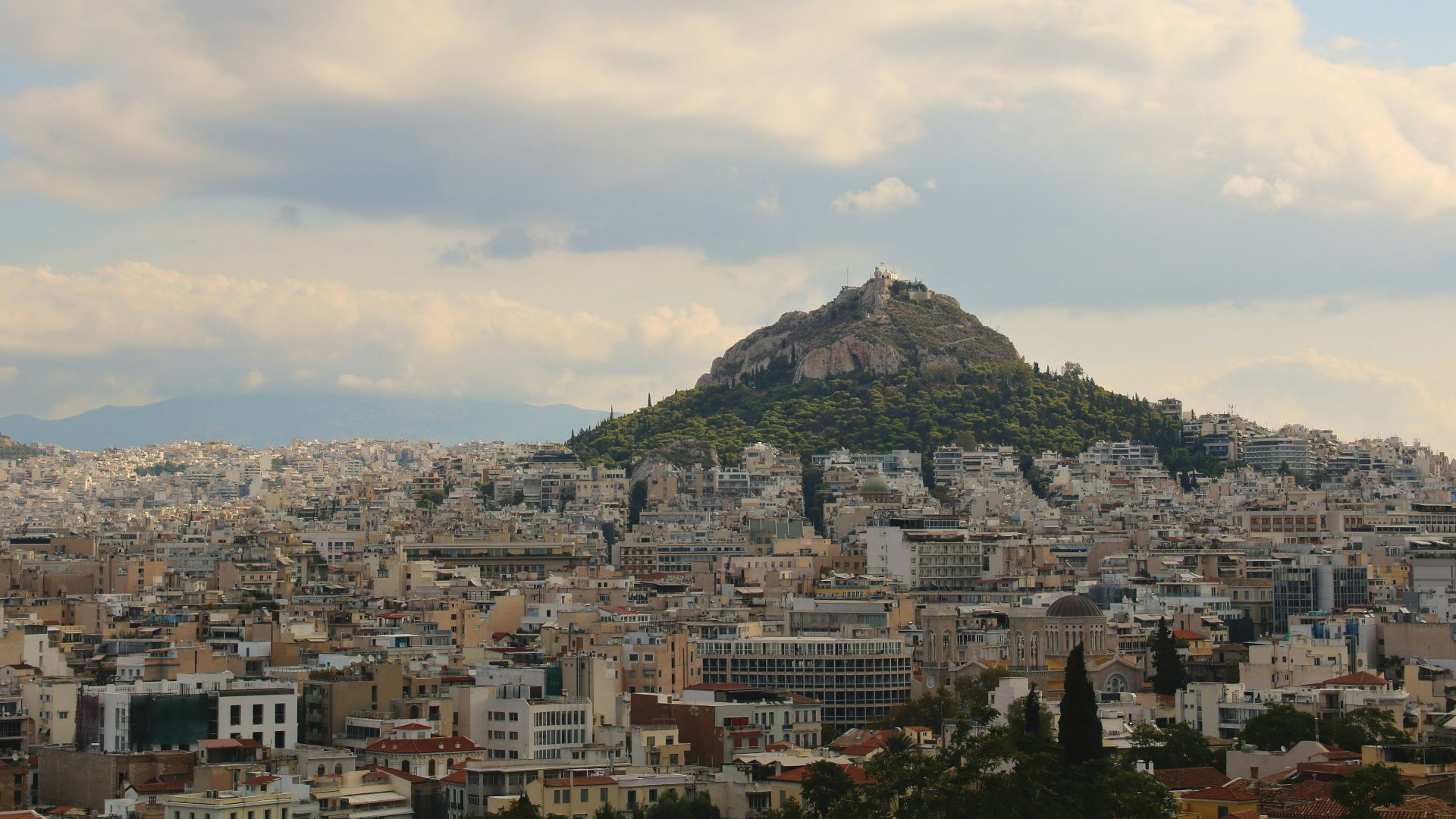 A view of a city with a mountain in the background