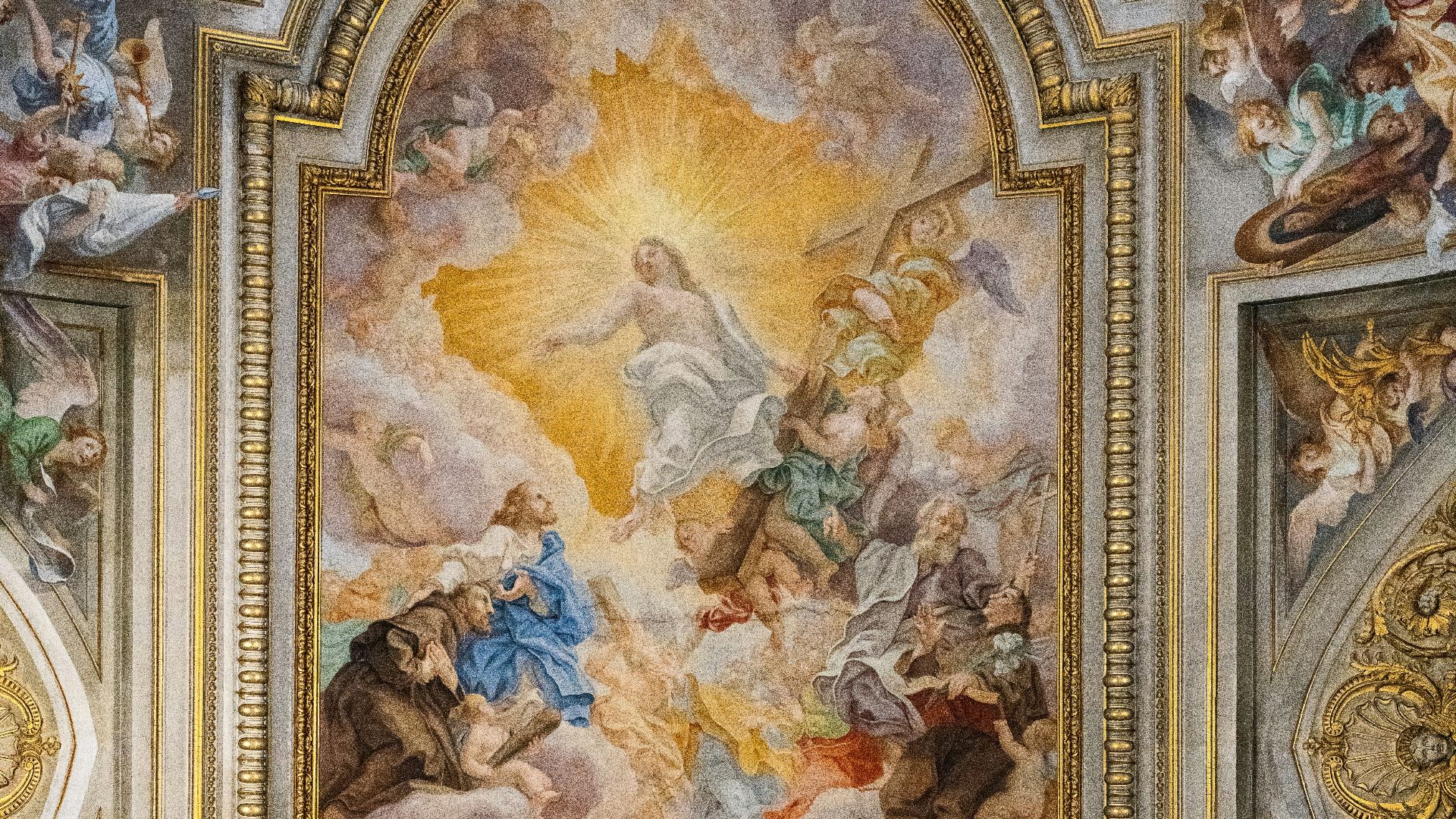 The ceiling of a building with a painting on it