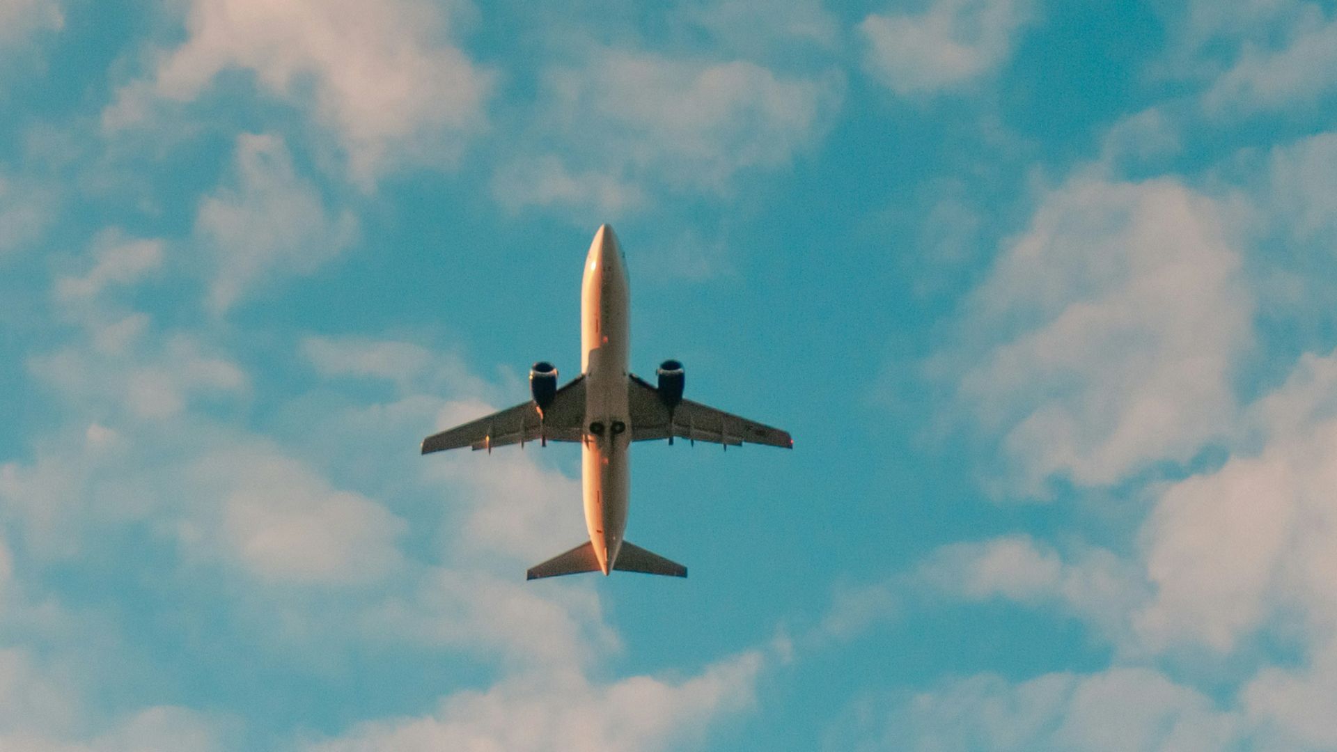 white airplane flying in the sky during daytime
