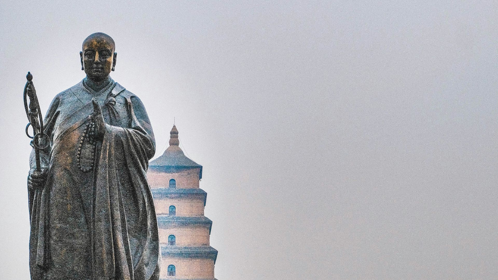 man in black coat statue