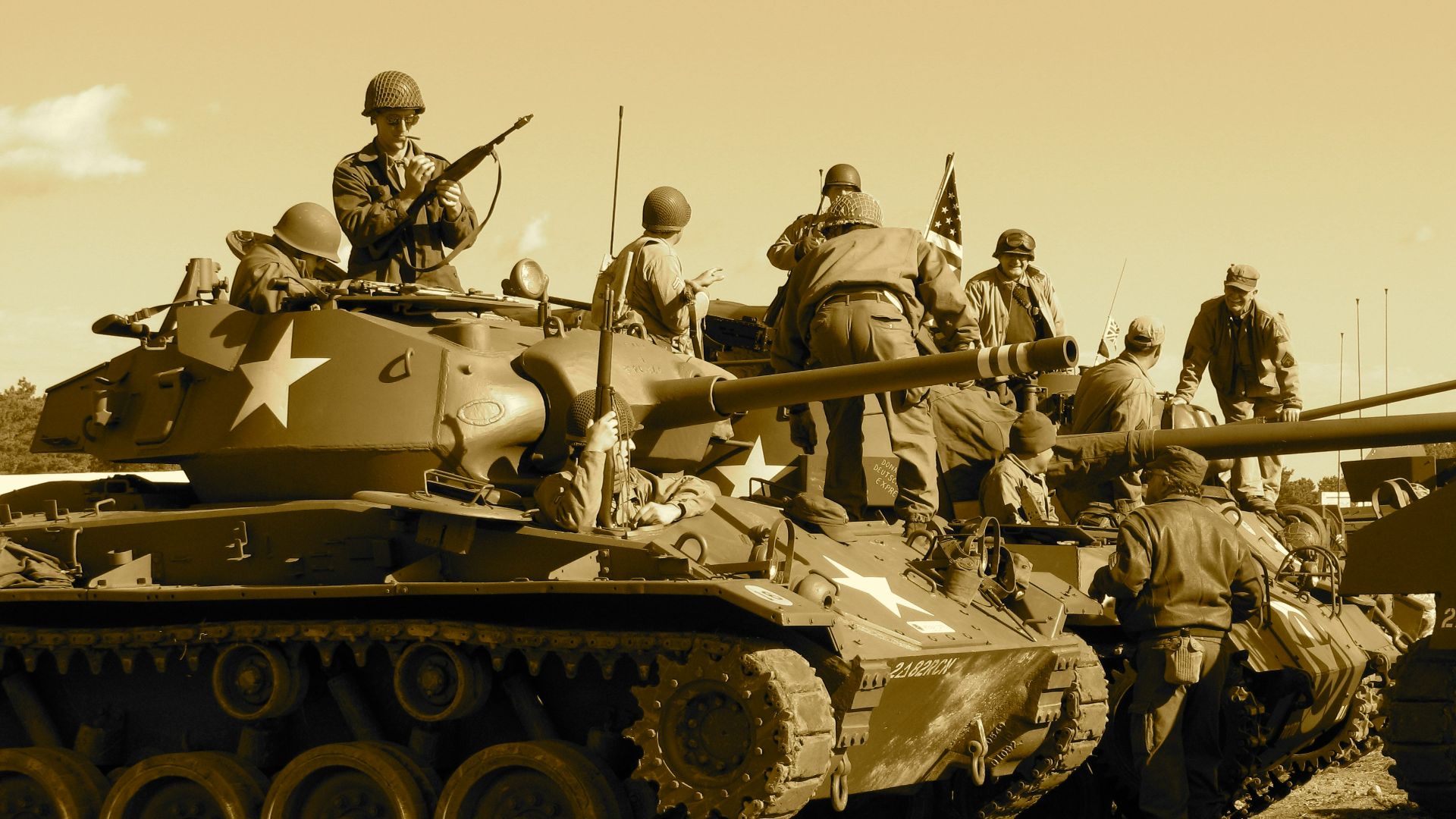 people sitting and standing on battle tank