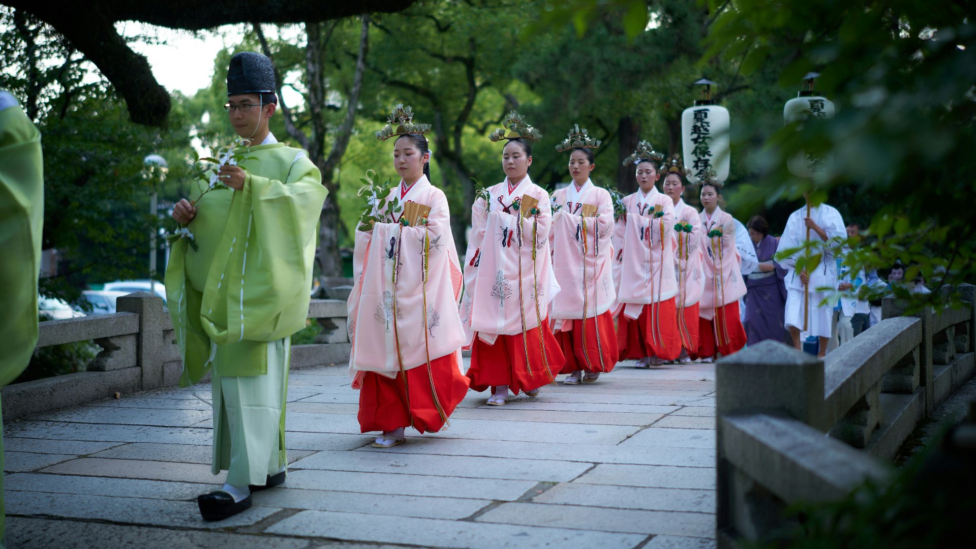 A group of people walking down a sidewalk