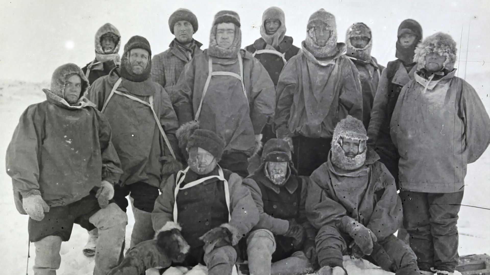 group of men in black coat on snow covered ground
