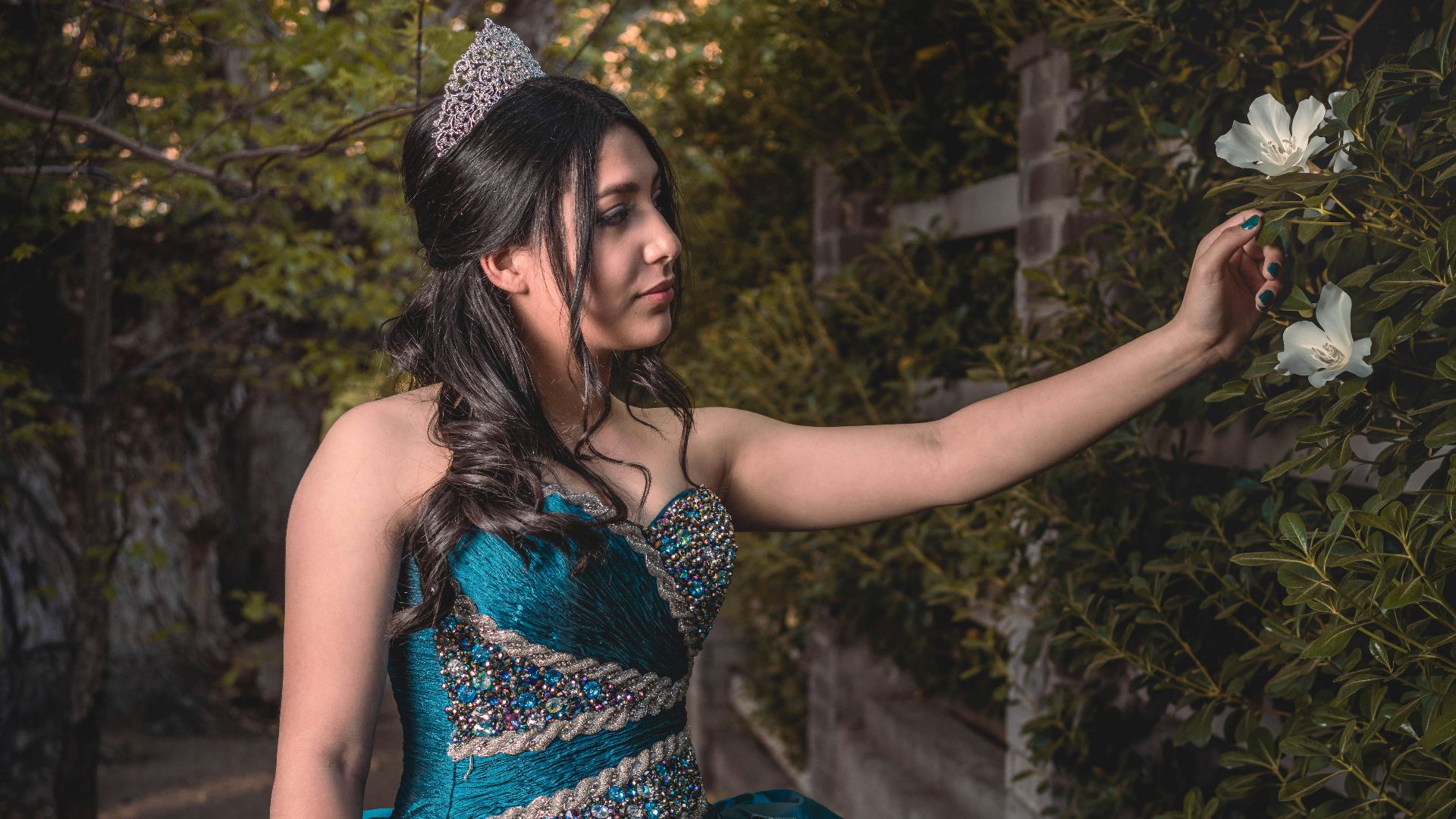 a woman in a blue dress holding a flower