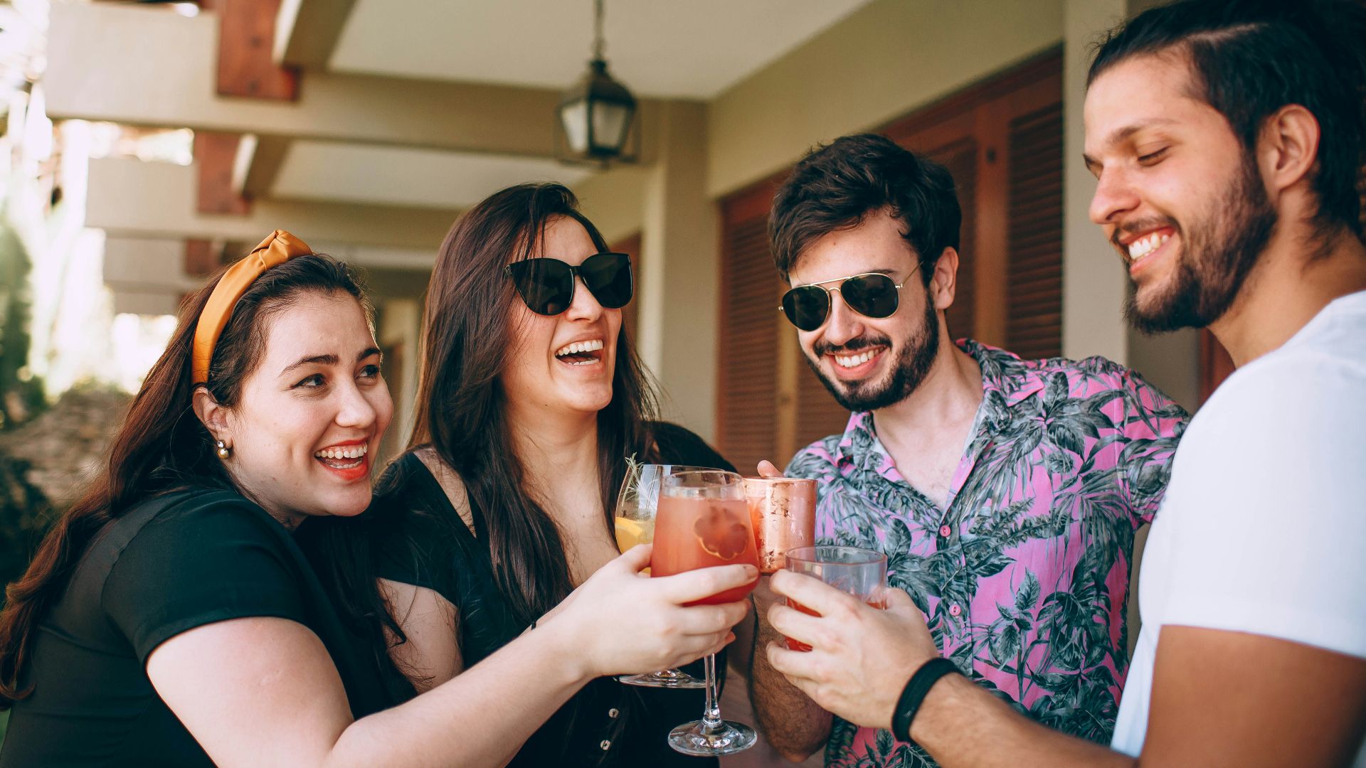 woman in black shirt holding drinking glass