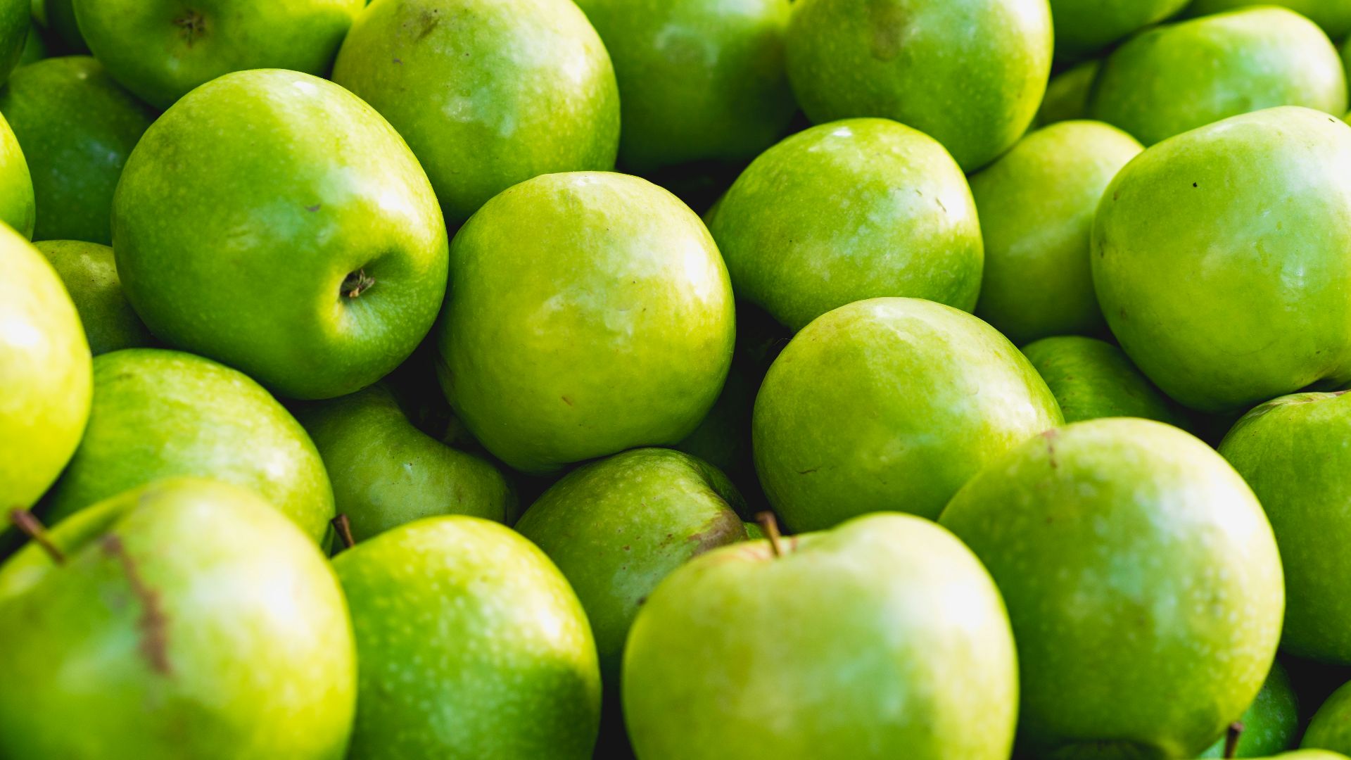 green apple fruit on brown wooden table