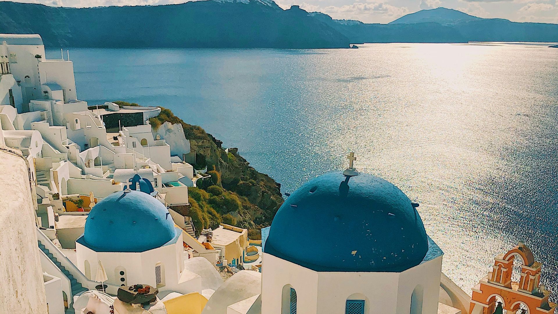 white and blue concrete building near body of water during daytime