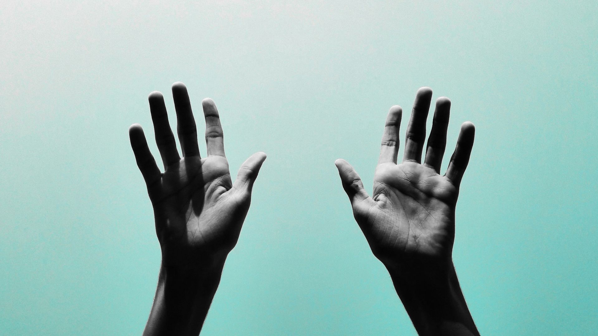 persons hand with black manicure