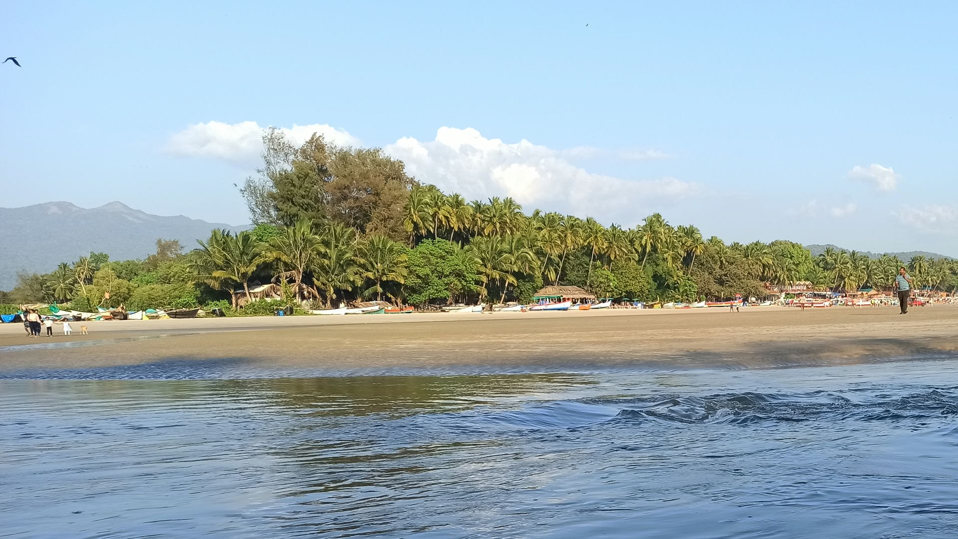 a group of people standing on top of a sandy beach