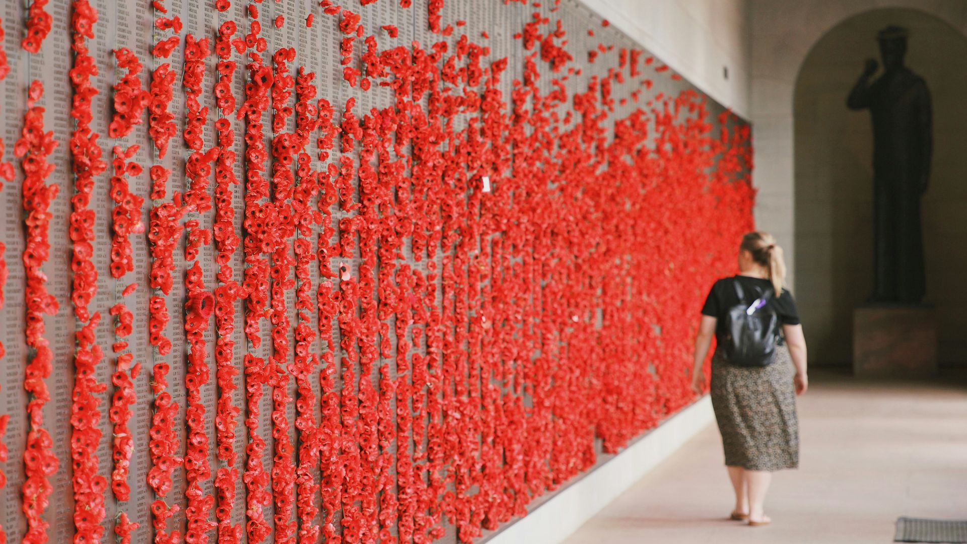 a person looking at a wall of red and white lights
