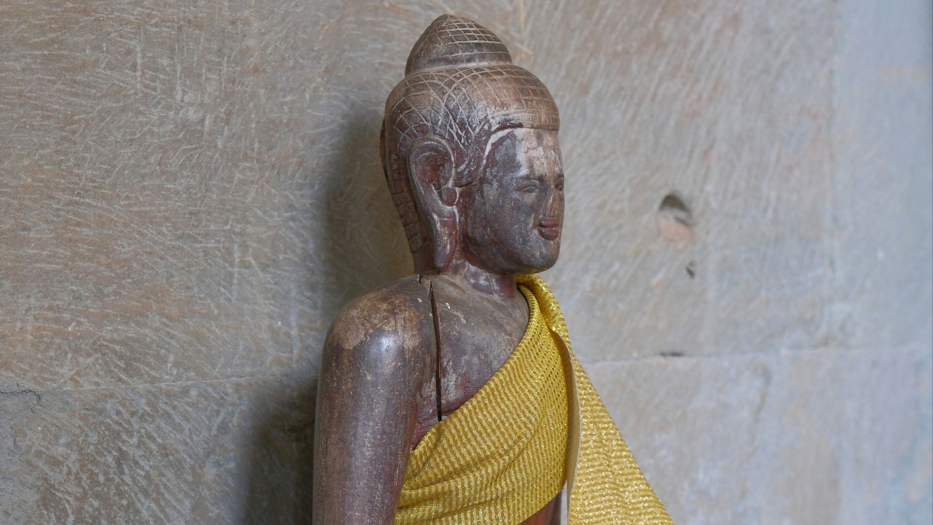 A statue of a person sitting on a bench