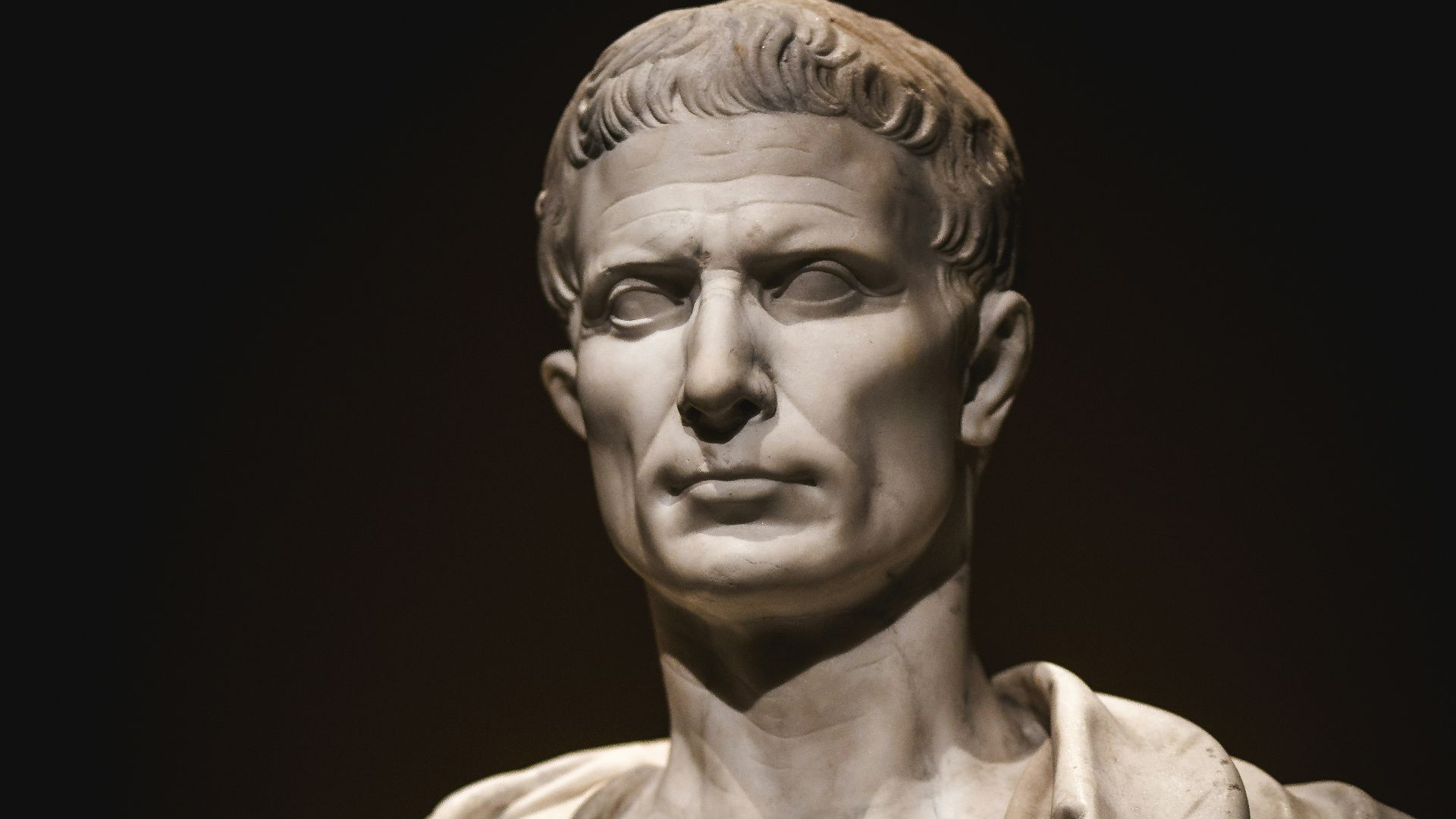 A bust of a man with a cape around his neck