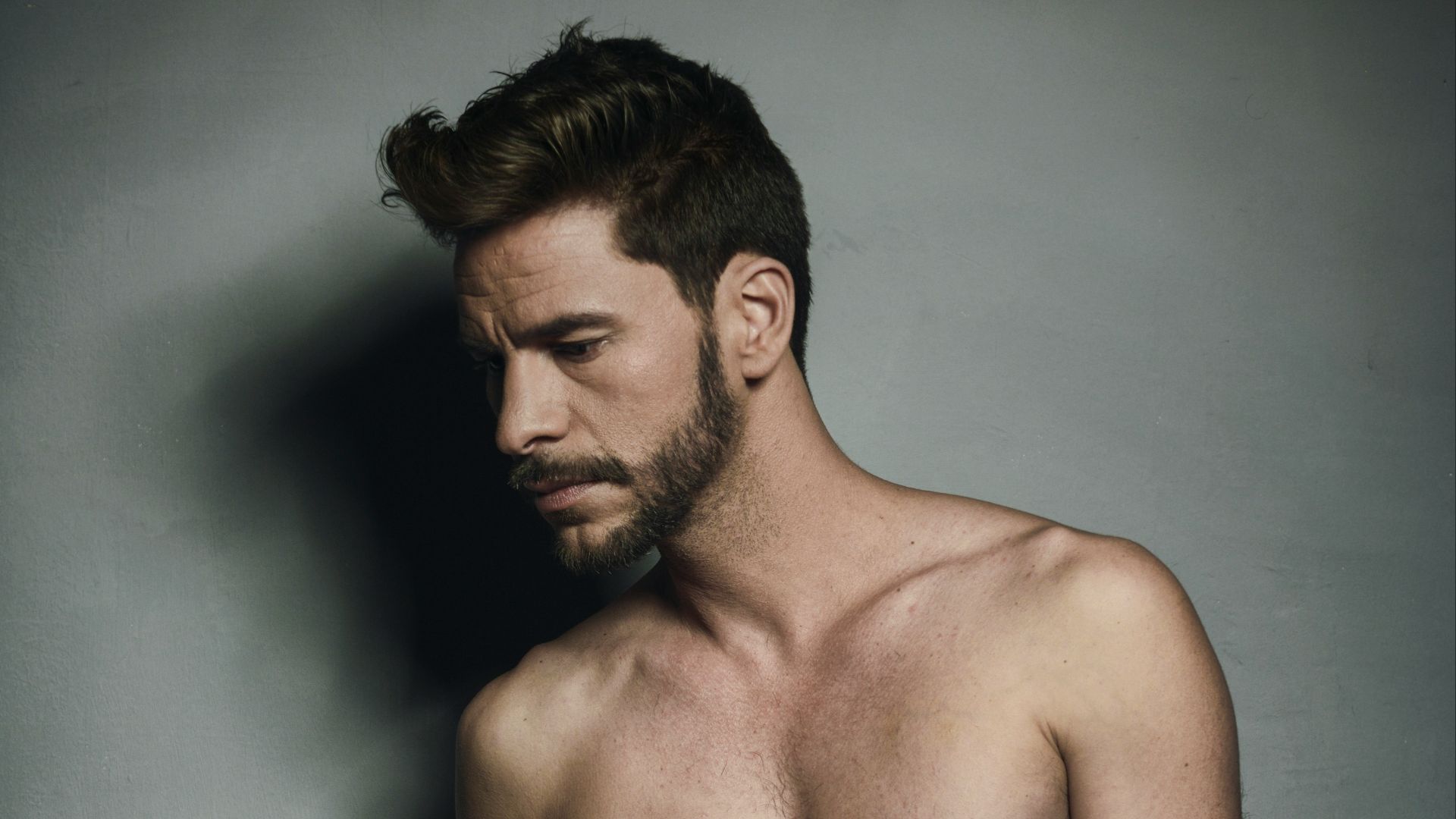 topless man wearing blue jeans