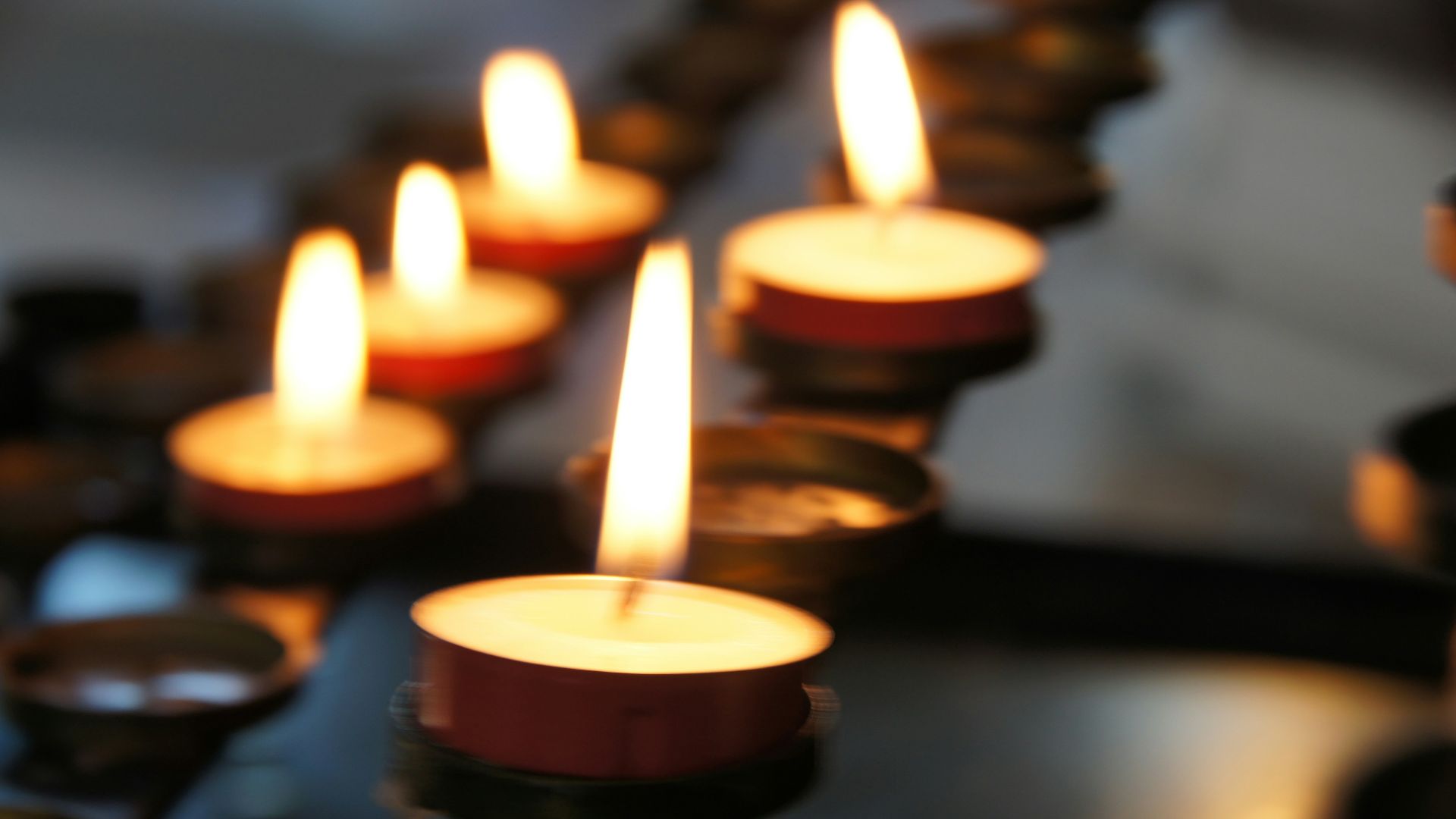 lighted candles on black metal candle holder