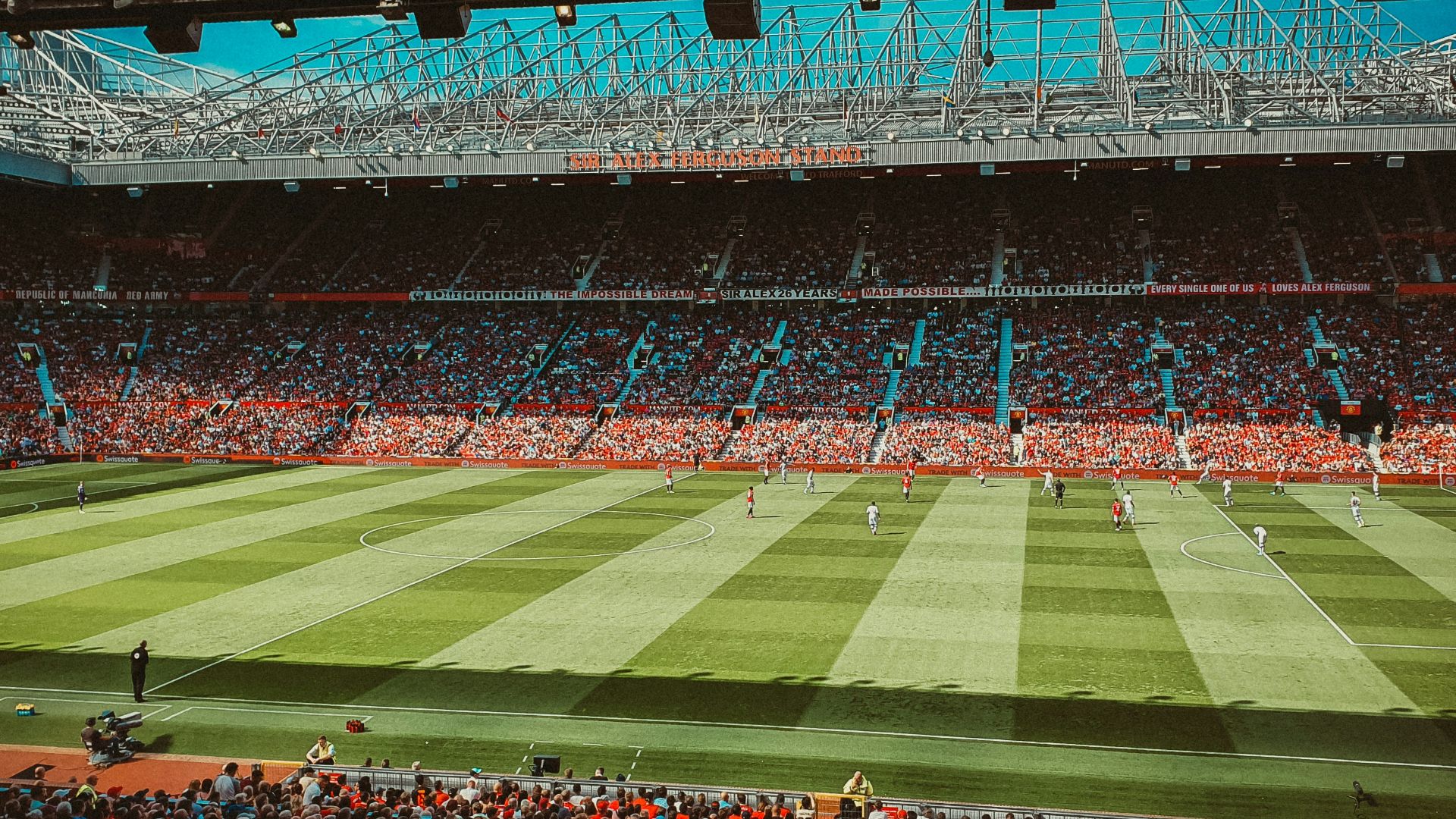 people watching football game during nighttime