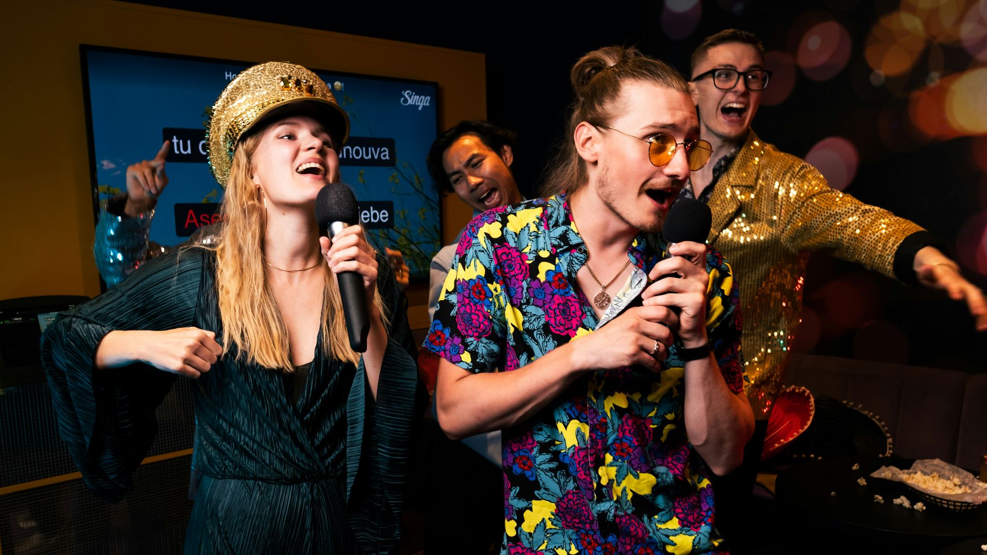 A group of people standing around each other in a room