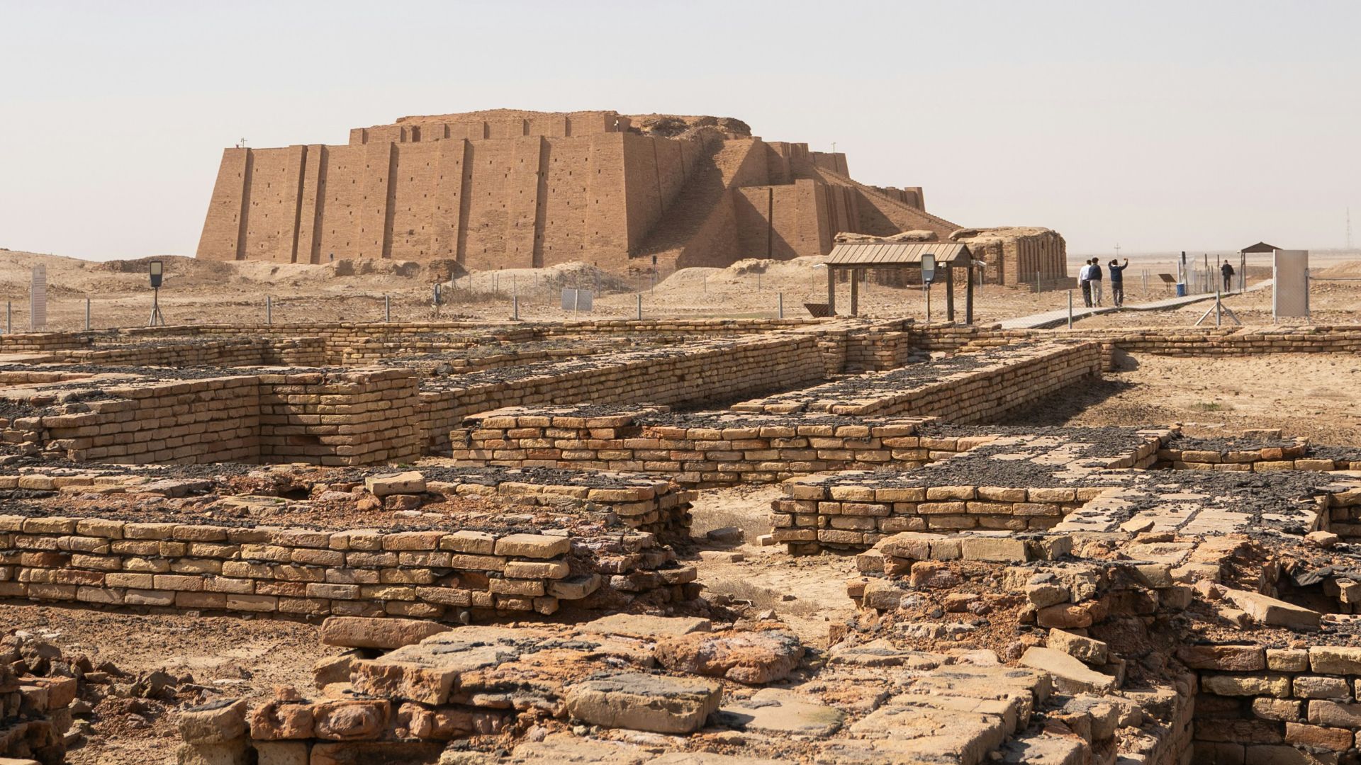 a group of people standing in front of a large structure