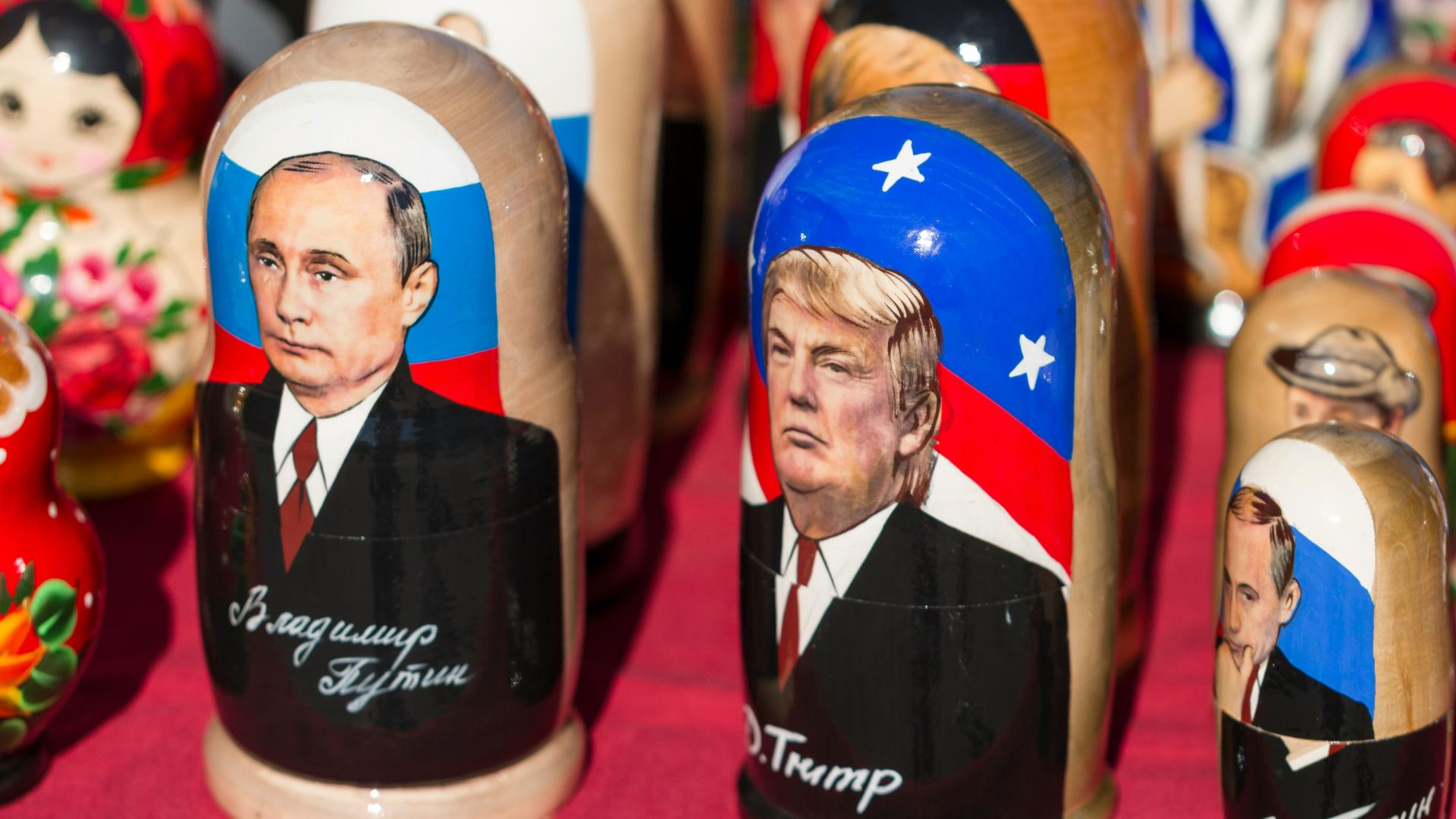 Donald Trump nesting dolls on red textile