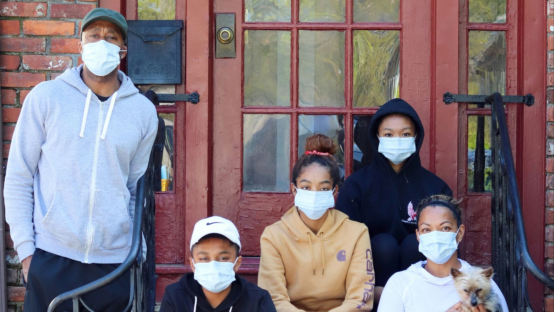 3 women and 2 men sitting on bench