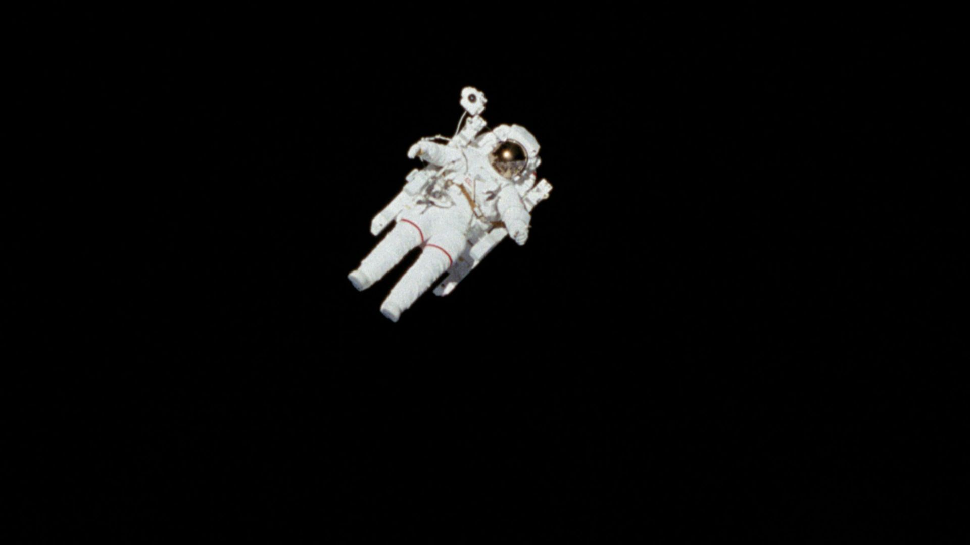 astronaut in spacesuit floating in space