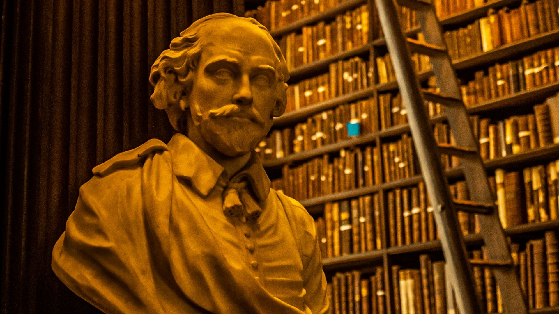 a bust of abraham lincoln in front of a library full of books