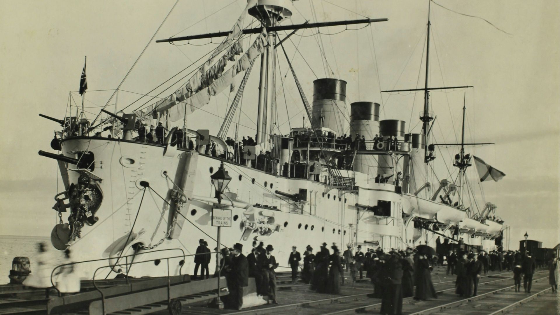 grayscale photo of ship on pier