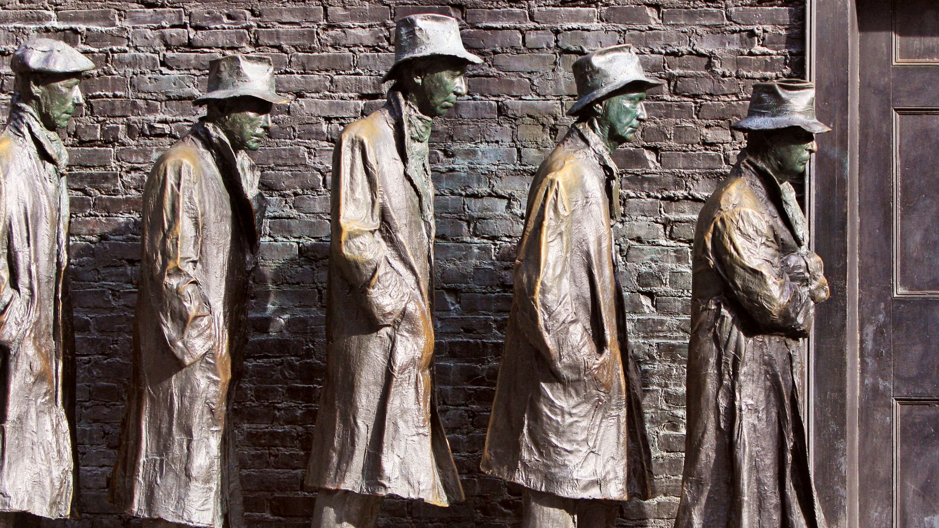 Bronze statues of men in a line