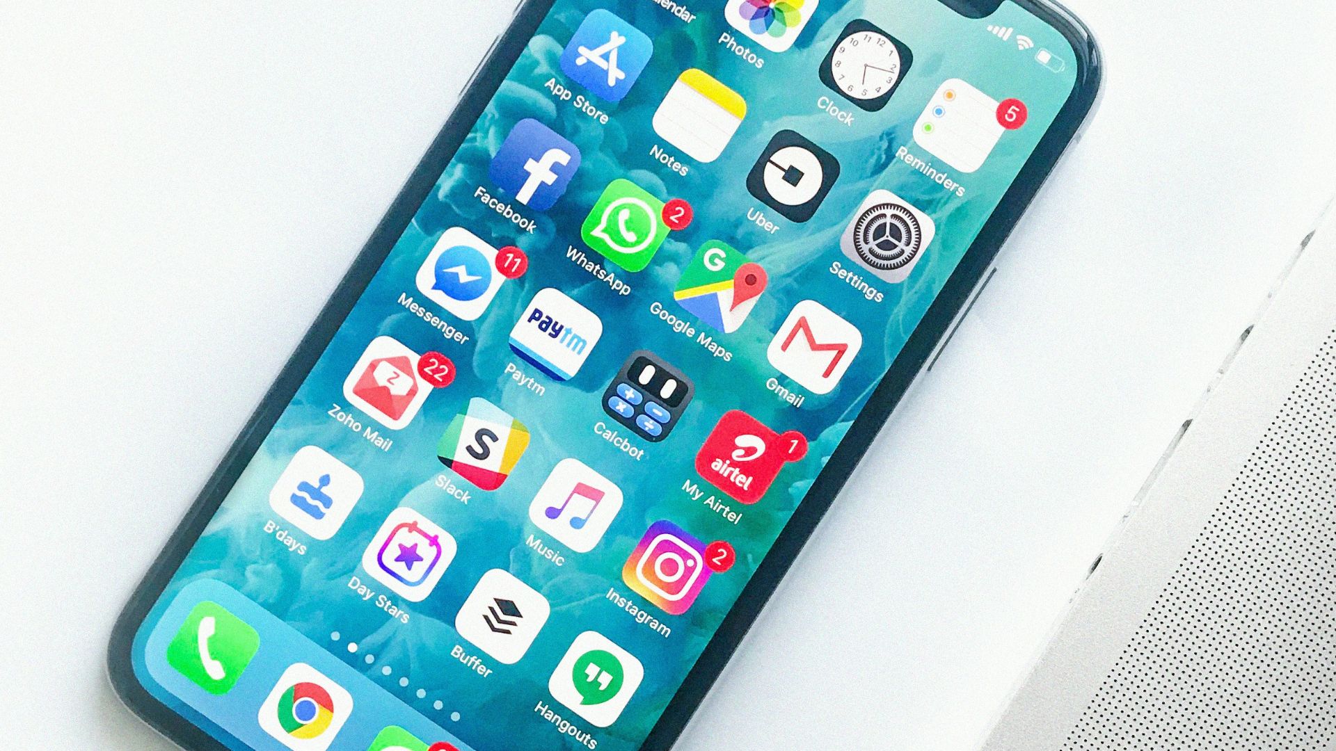 white smartphone near laptop