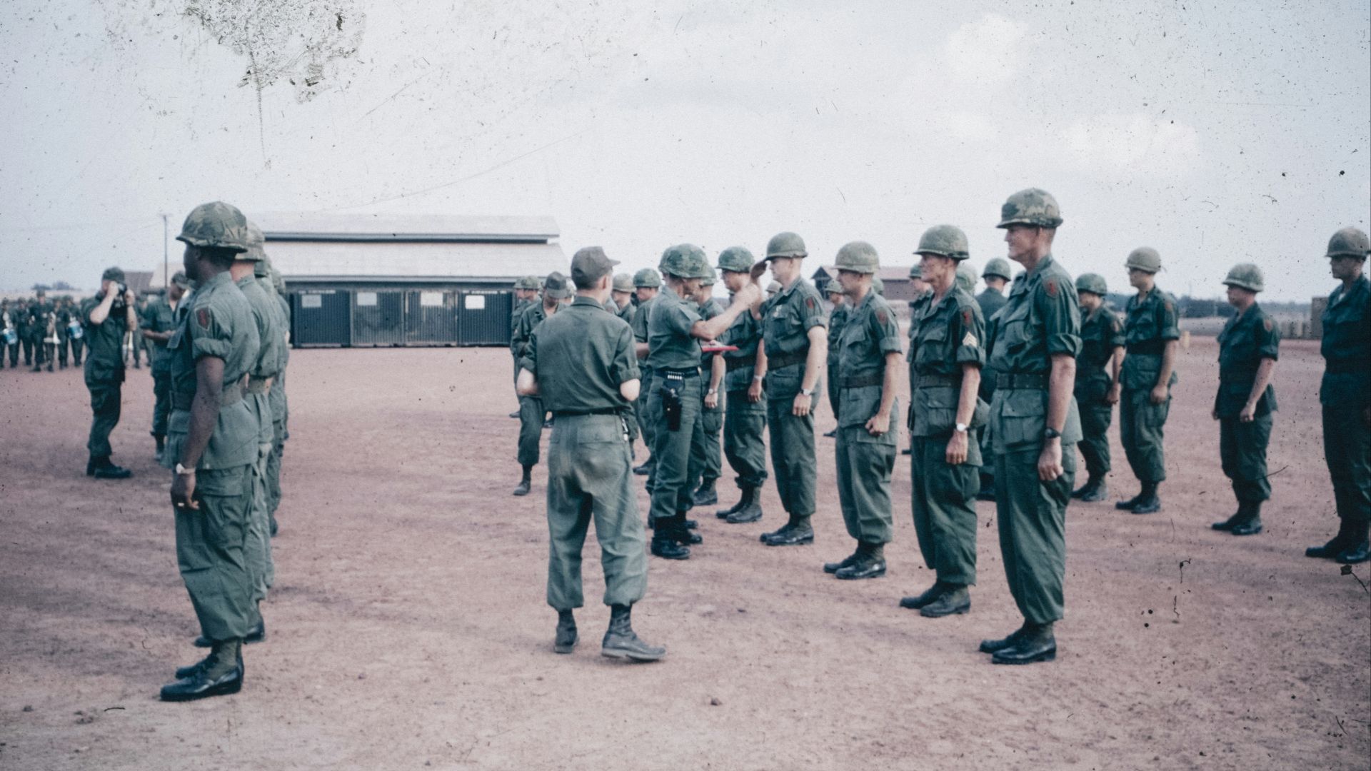 A group of men in military uniforms standing in a circle