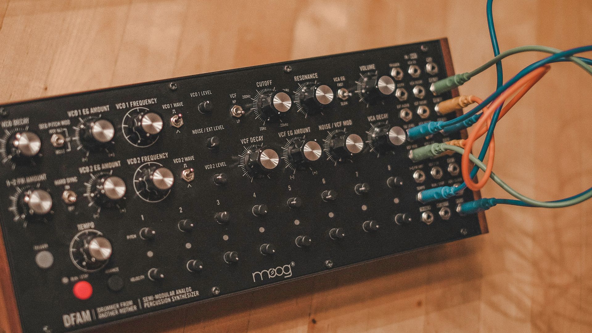 A close up of a remote control on a wooden table