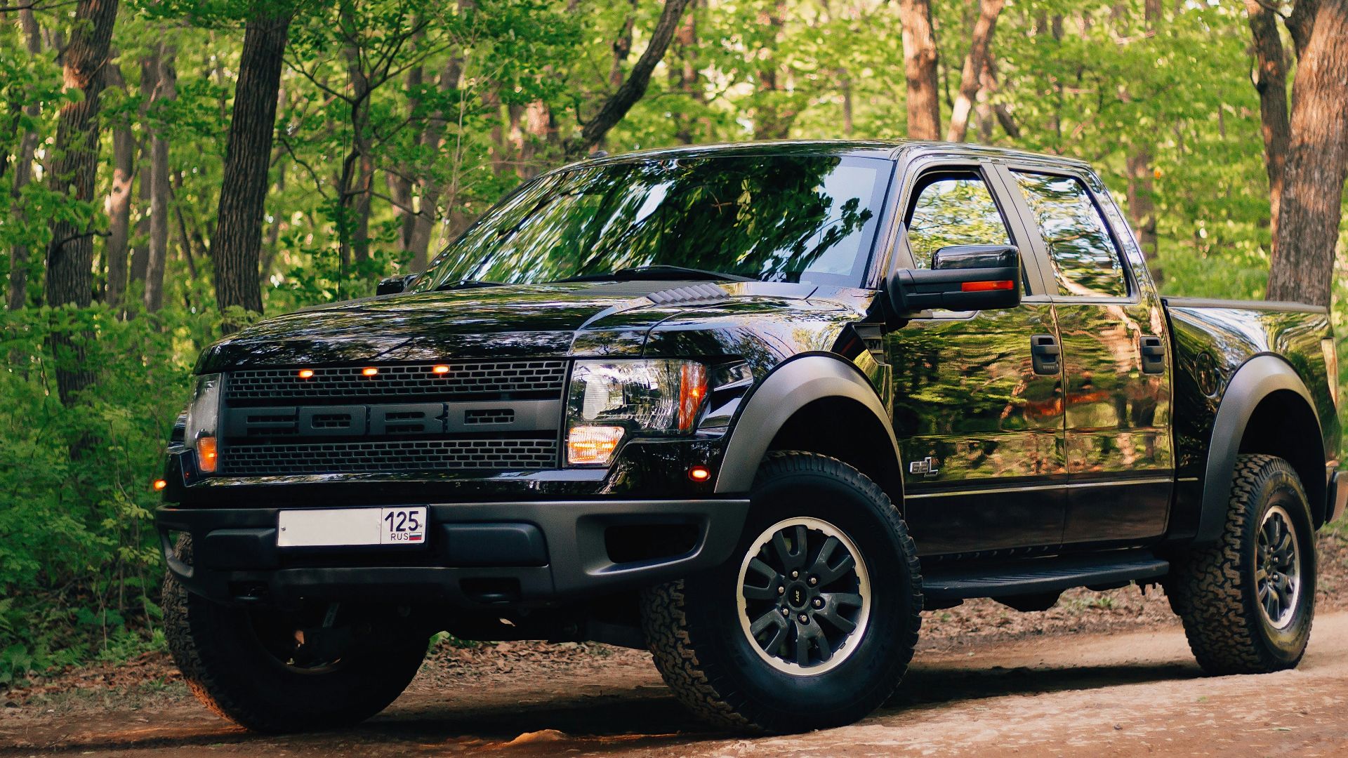 black and yellow chevrolet crew cab pickup truck parked on dirt road during daytime
