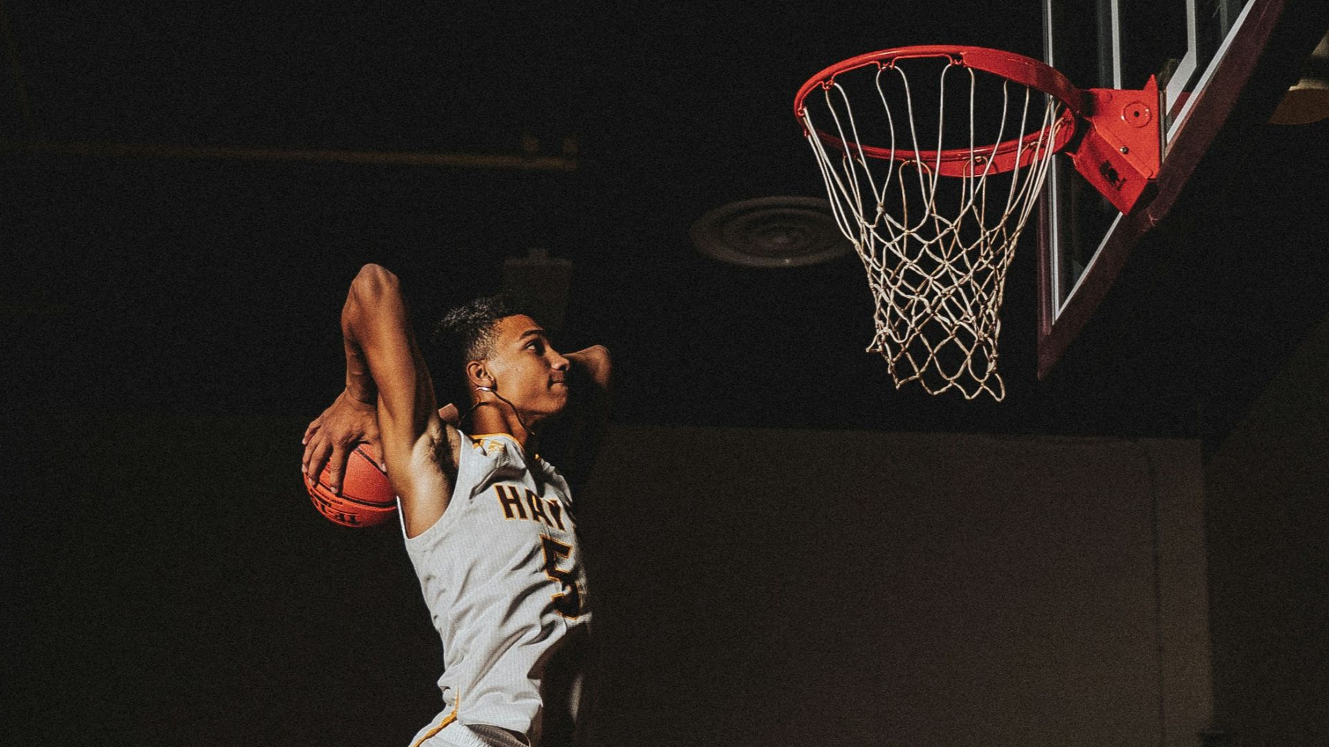 2 boys playing basketball on basketball court