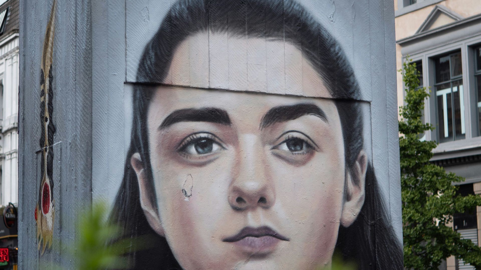 man in black shirt standing near building
