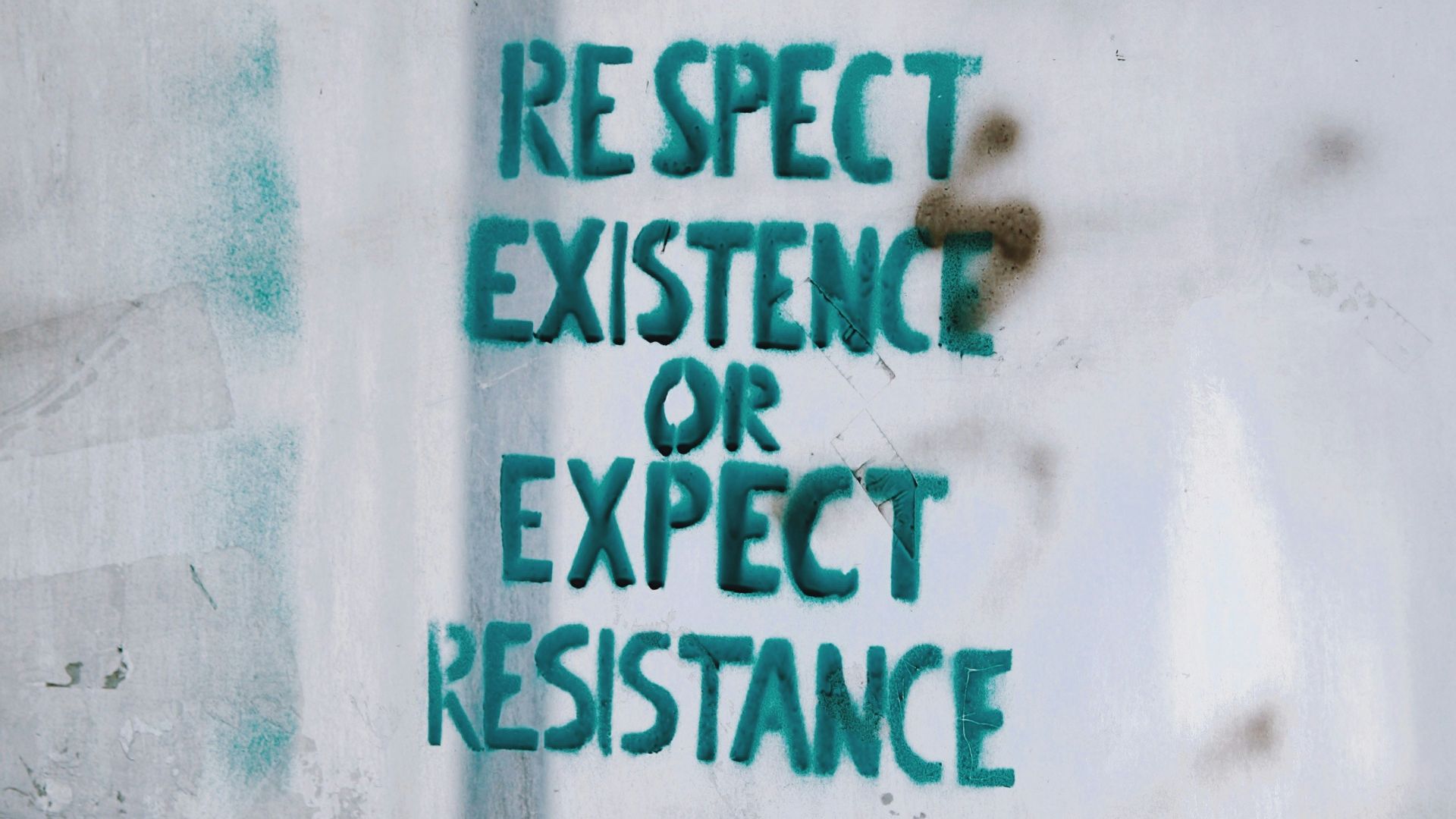 respect existence or expect resistance text on glass board