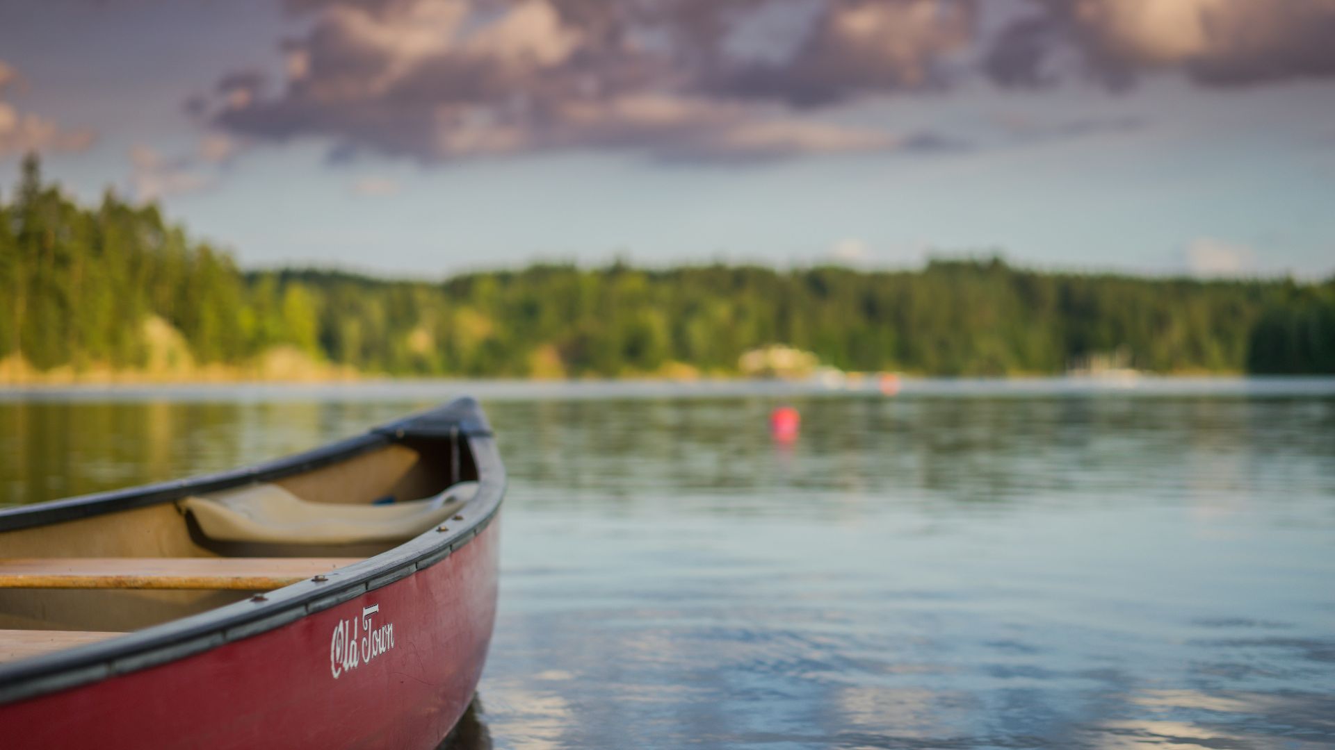 red canoe boat on body of water