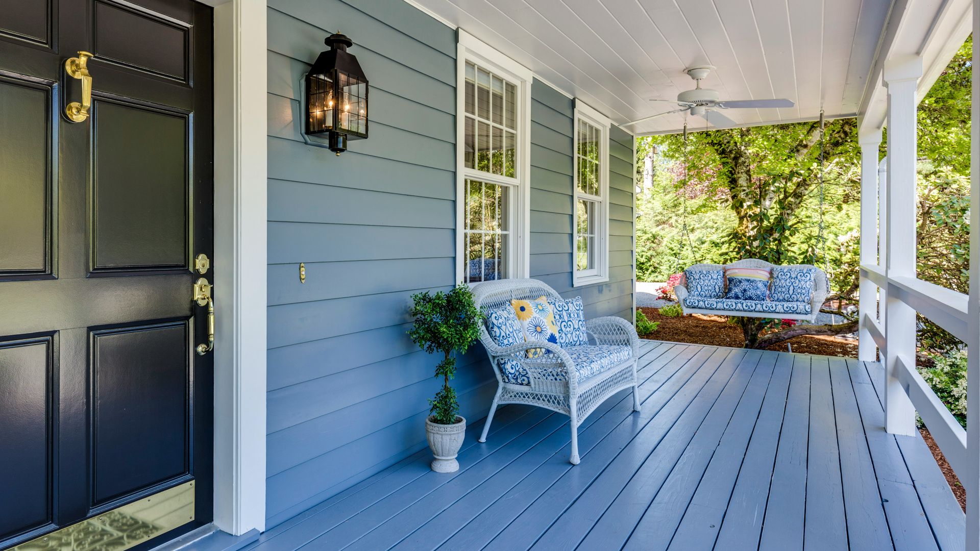 a porch with two chairs and a table on it