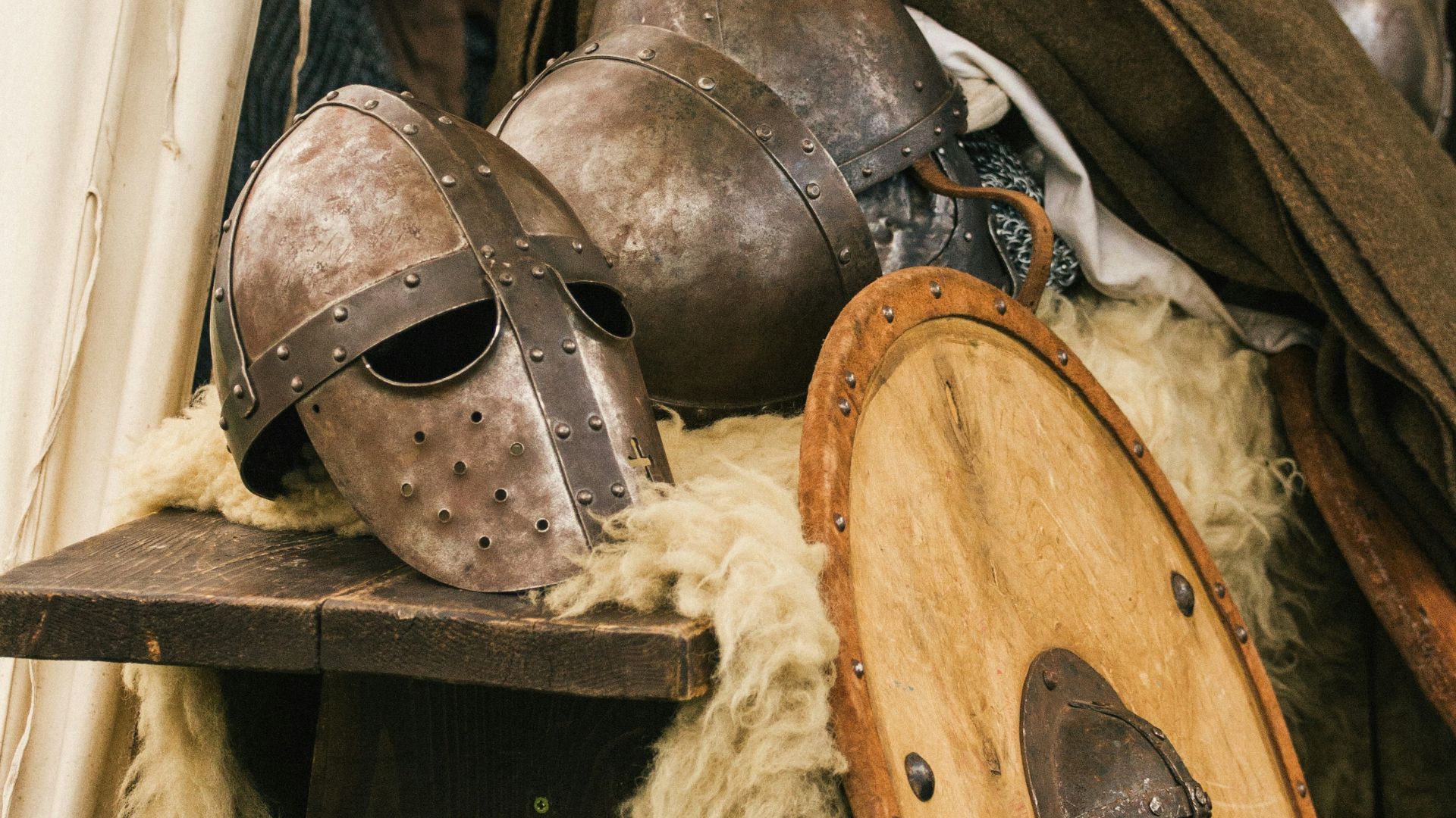 brown wooden round table with brown leather boots
