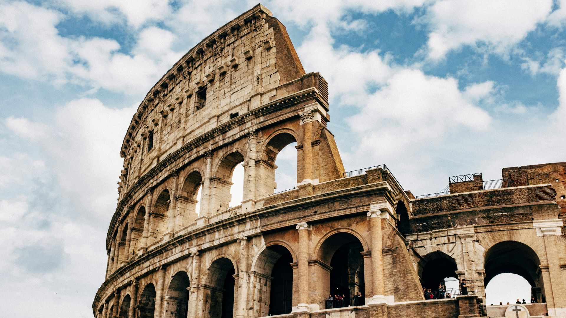 Colosseum under white clouds during daytime