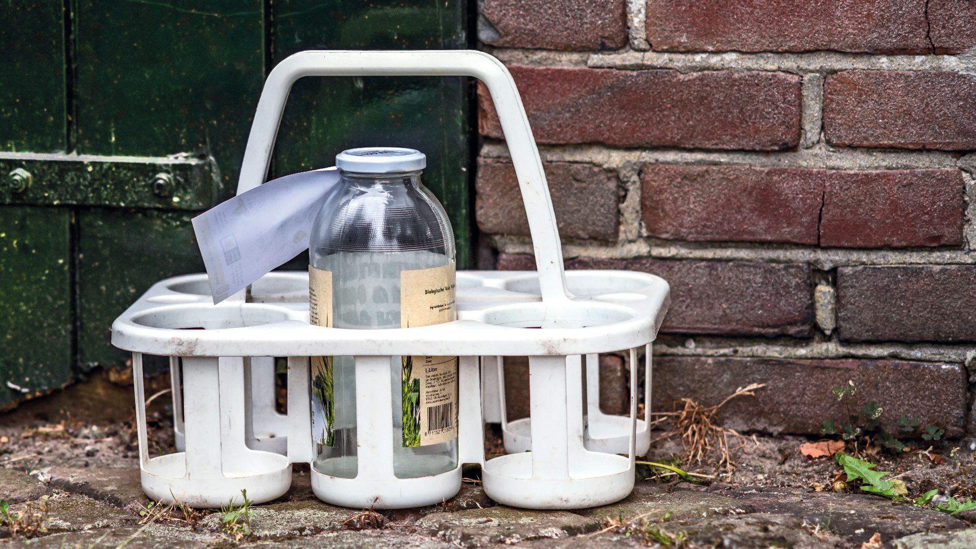 a white basket with a bottle on top of it
