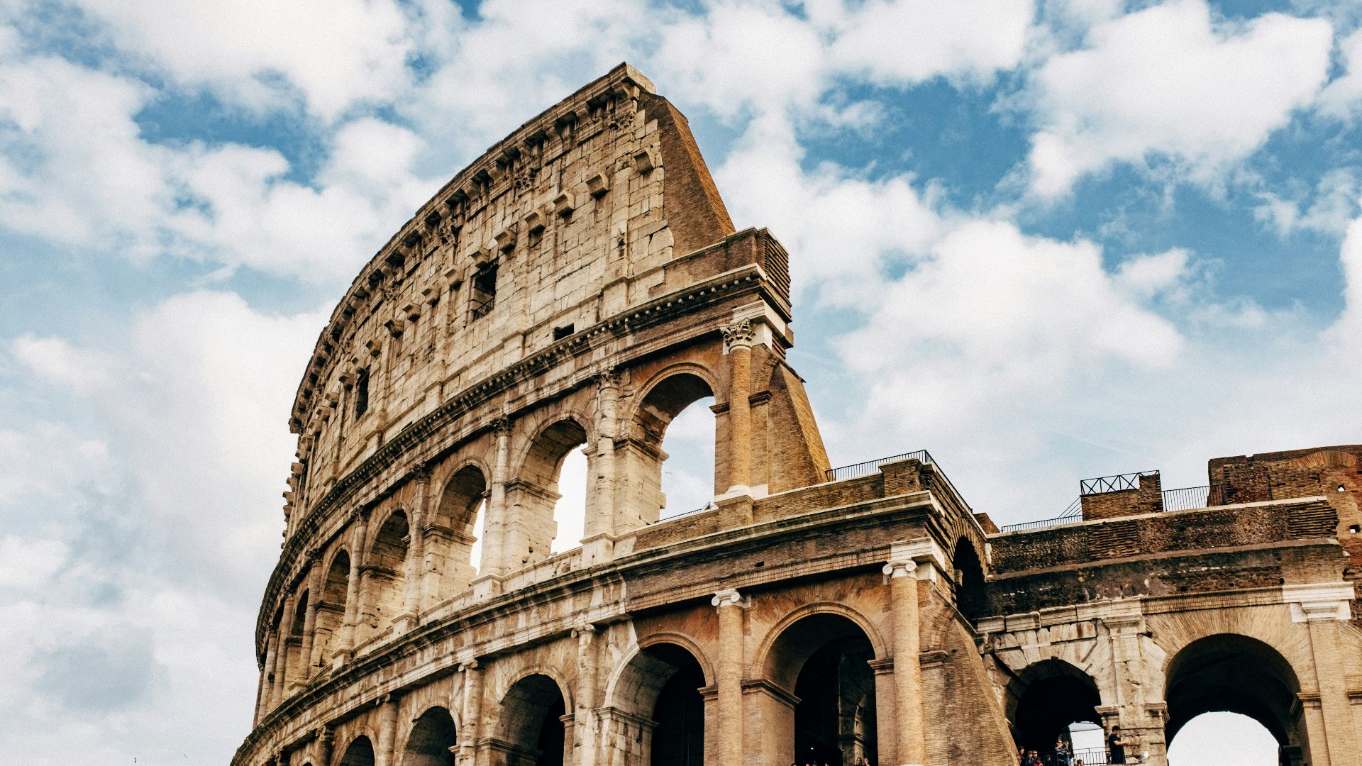 Colosseum under white clouds during daytime