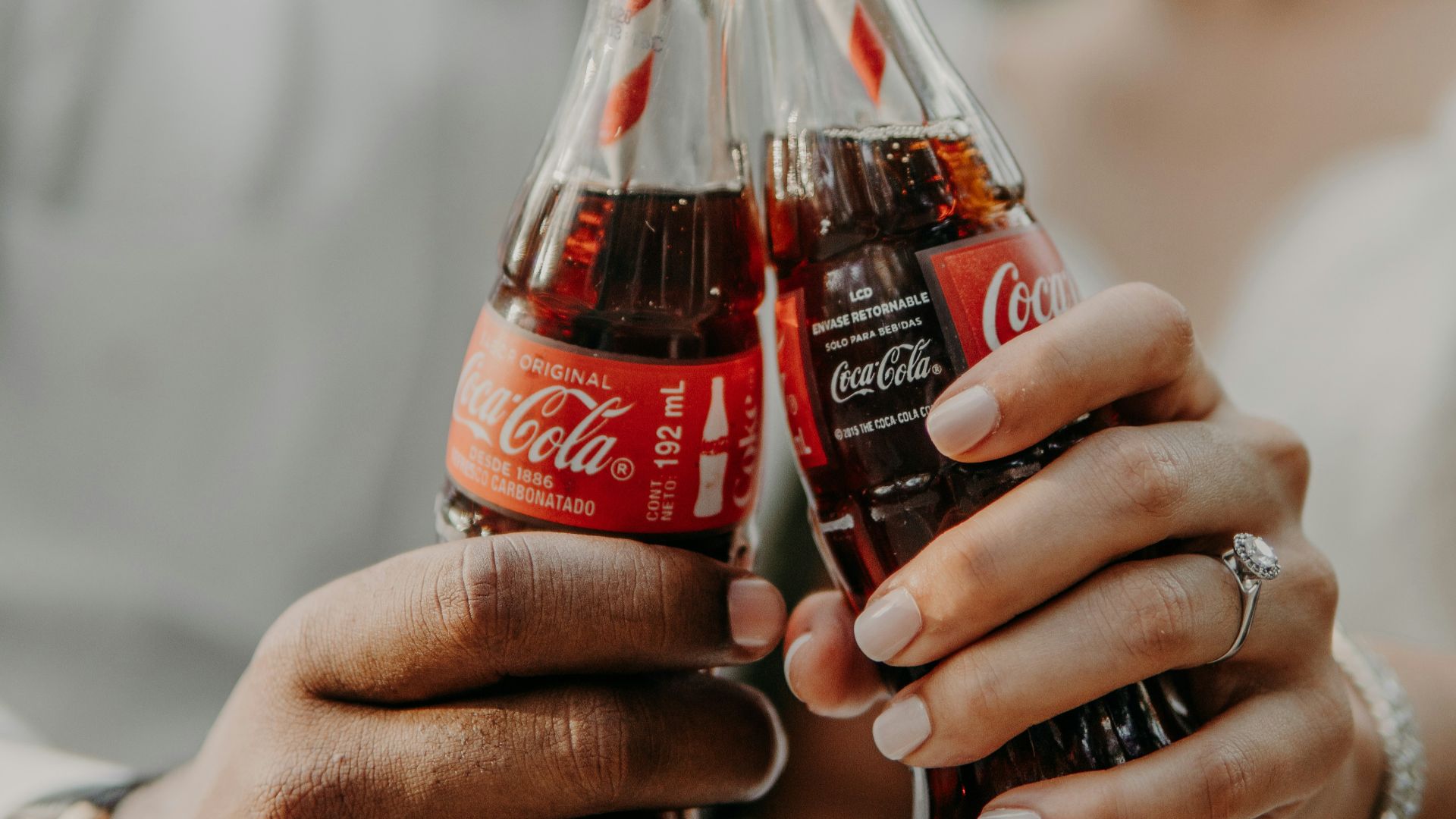 person holding coca cola bottle