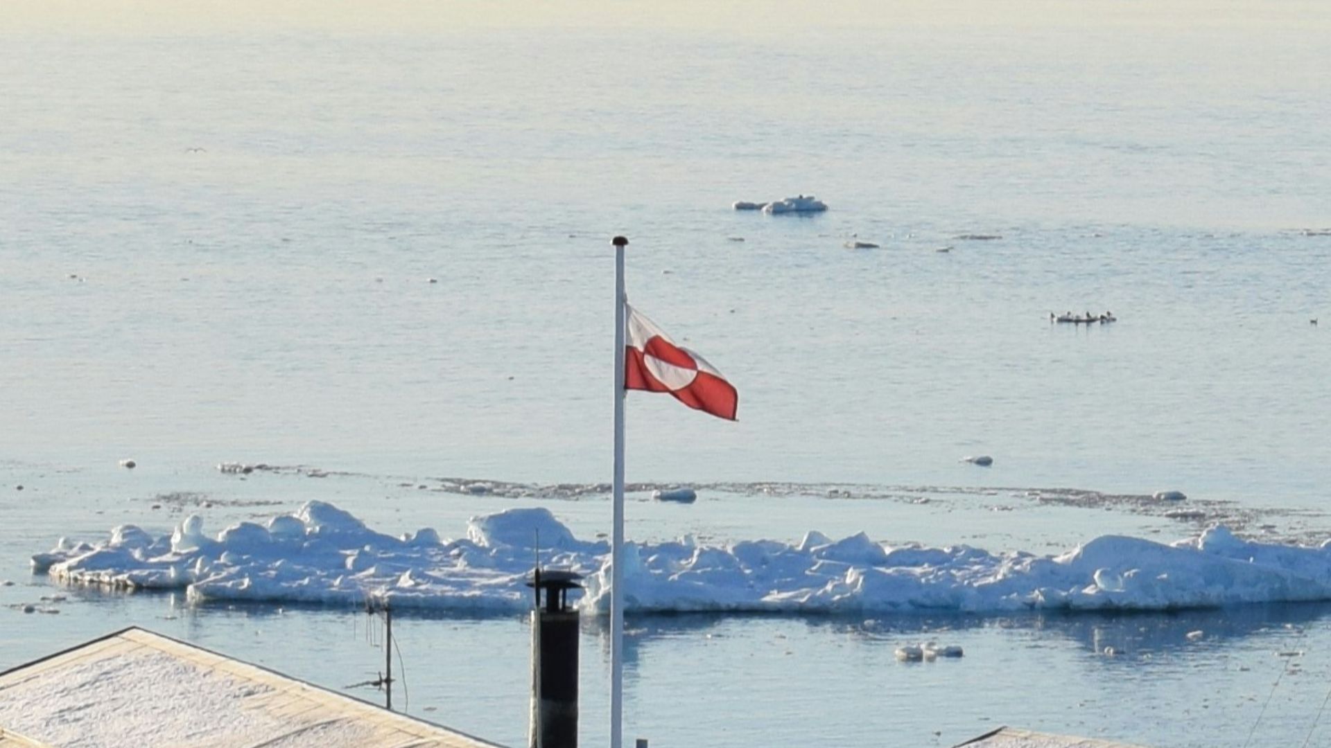 white and blue concrete building near body of water during daytime