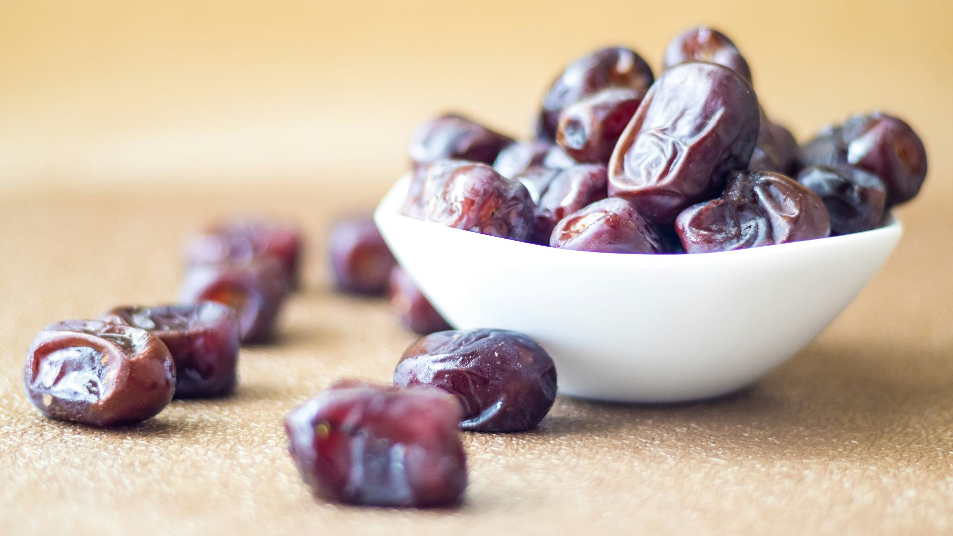 brown round fruit on white ceramic bowl